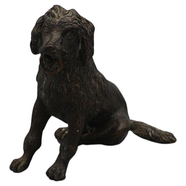 A late 19th century cocker spaniel holding a toy in it's mouth. Bronze. 

