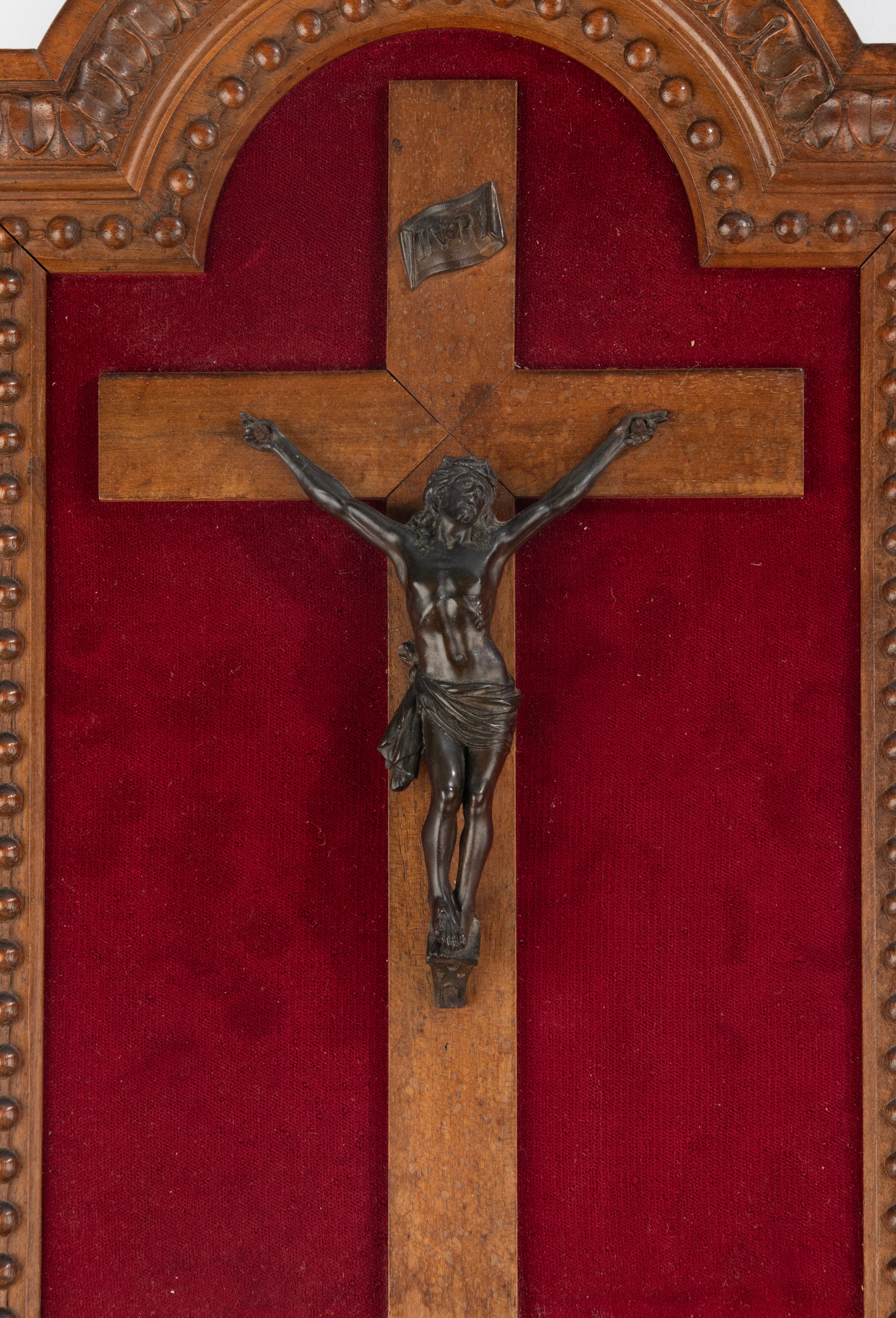 A beautiful bronze figure of Jesus Christ, a Corpus Christi. It hangs on a walnut cross, the frame is also made of walnut, with fine carvings. 
This piece dates from circa 1890. It is in very good condition, the bronze has a beautiful antique