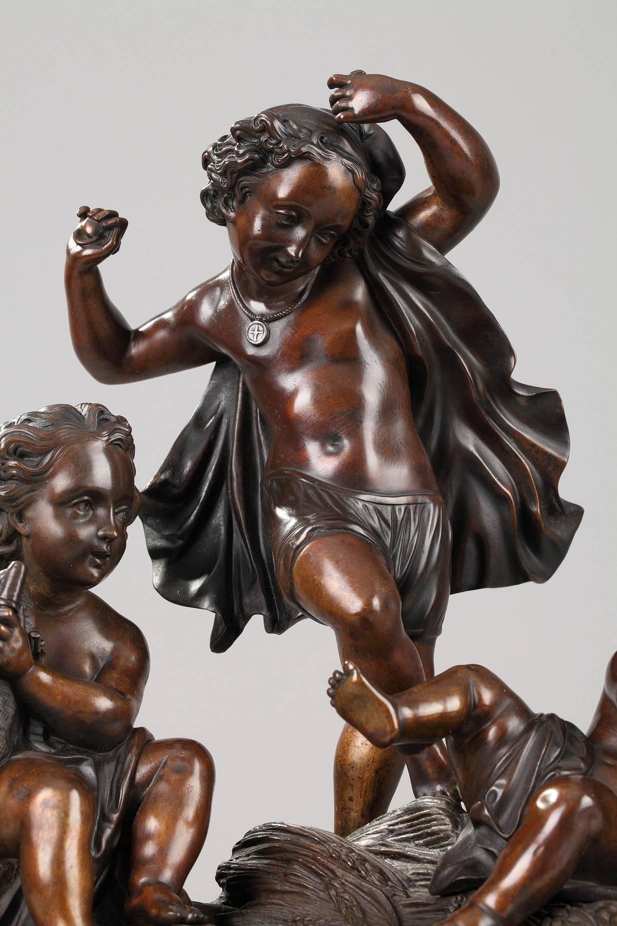 Patinated bronze allegorical group featuring three putti on a cliff strewed with wheat. Two of them are playing the drum and the bagpipe whereas the third one is dancing. He is wearing a floating drape and is playing the castanets. Beautiful brown