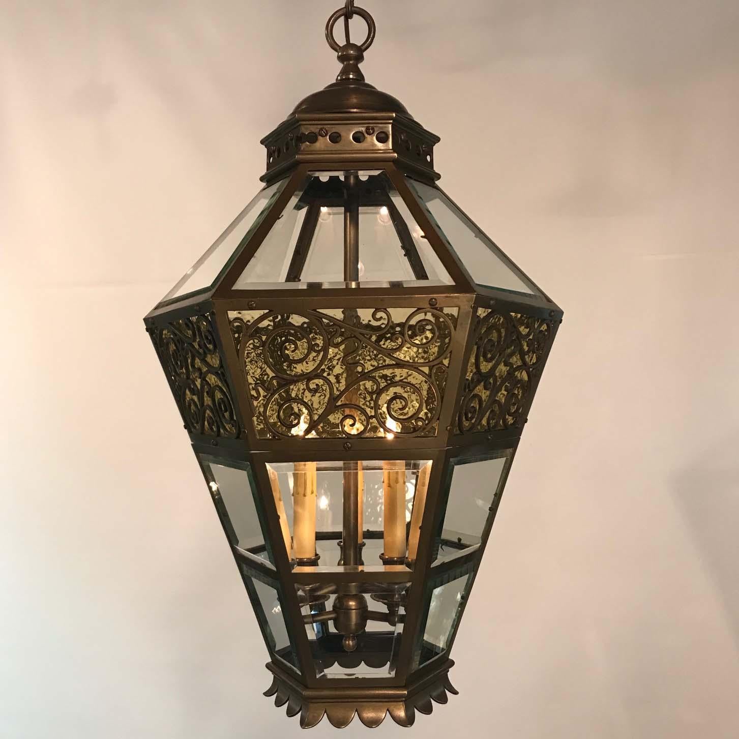 This large and impressive lantern was originally fitted for gas. It is tapering and hexagonal with each paneled side set with the original beveled grass plate. A broad cast band is applied to the top with a pebbled glass behind. This artfully