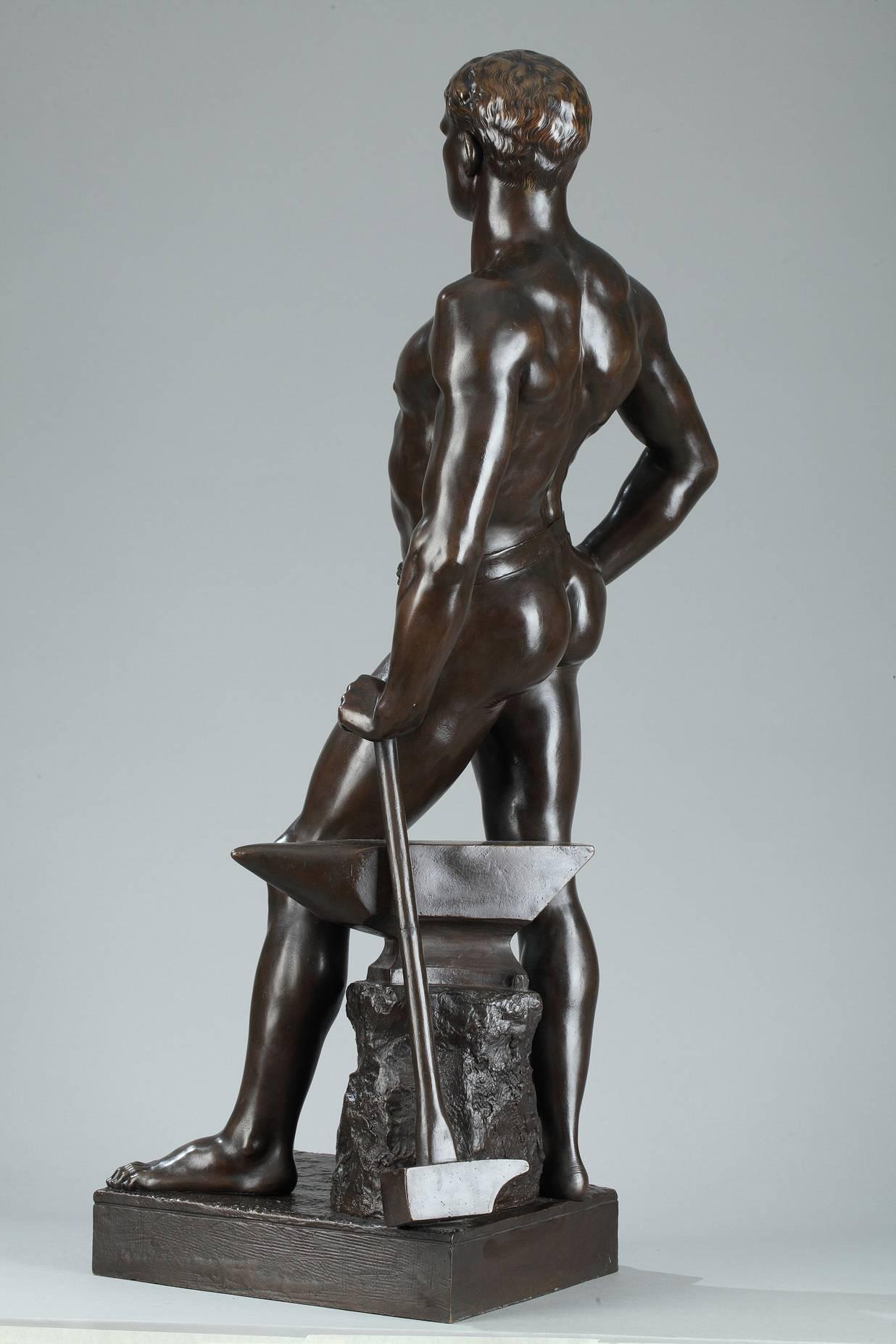 Bronze sculpture with brown patina featuring a blacksmith standing while leaning against his anvil and hammer. He is presented nude, standing in contrapposto, his left leg forward and slightly bent and set on a square base. The title sculpted on the