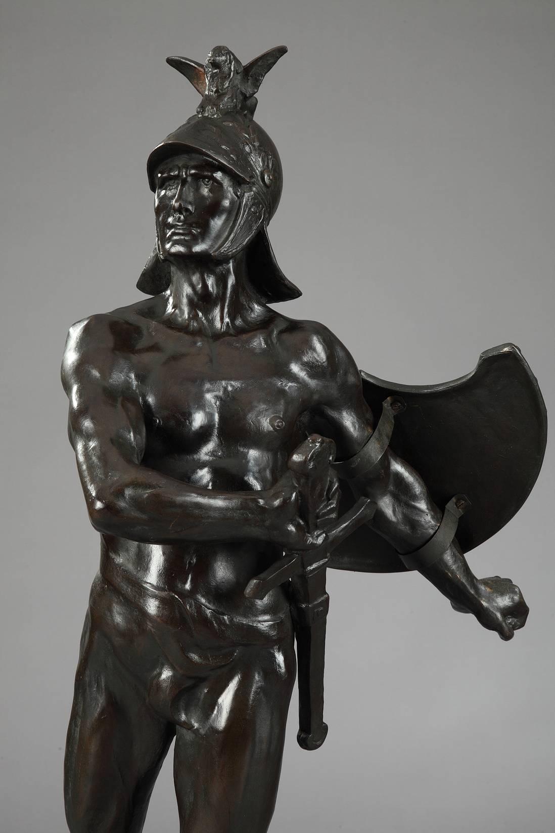 Large patinated bronze figure of an Antiquity warrior. He is set on a base decorated with battle scenes, marked: Les Chasseurs Éclaireurs de Bruxelles à leur Lt Colonel O. Tahon 1870-1910 (The Hunters Scouts from Brussels to their Lt Colonel O.
