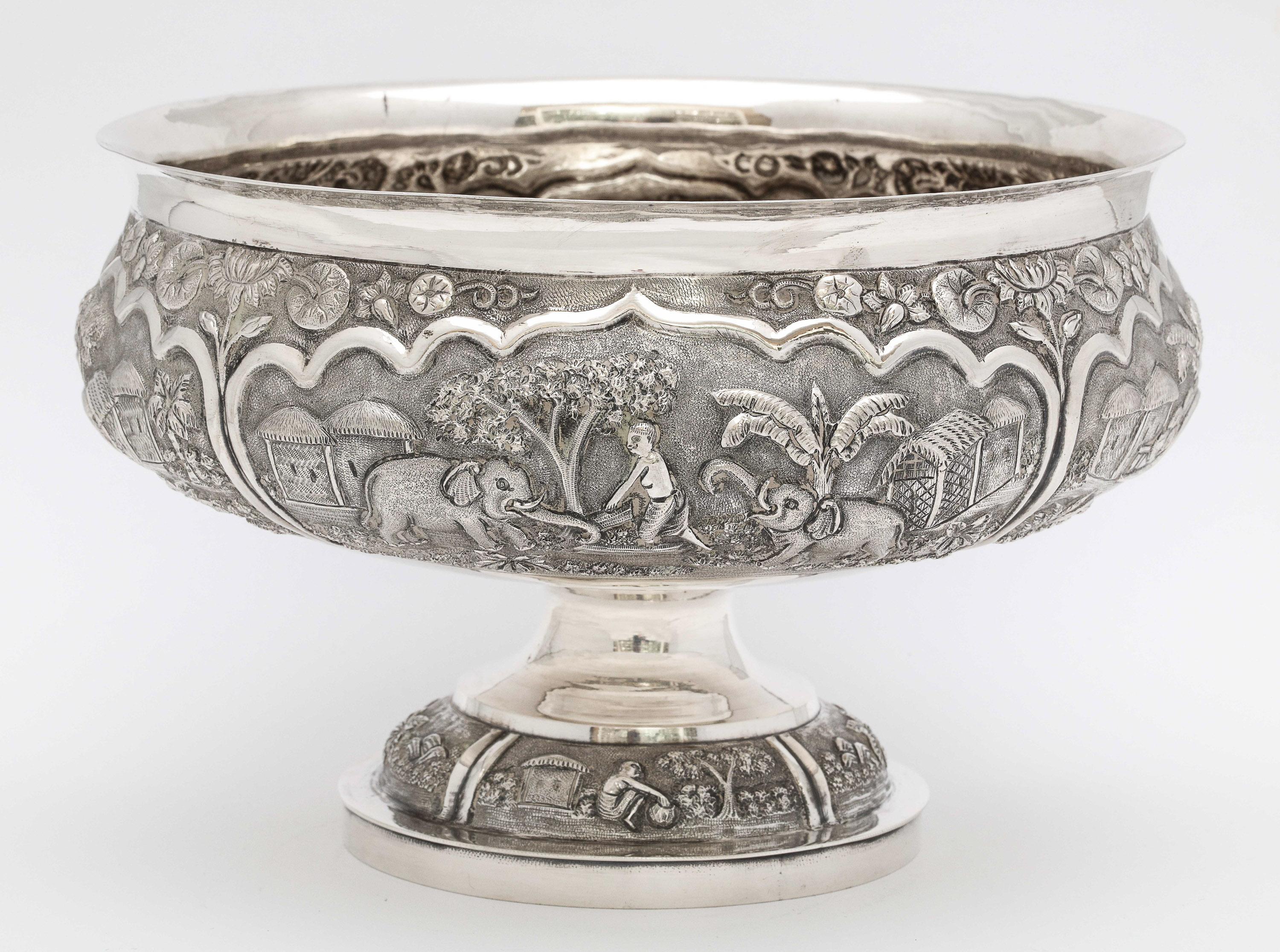 Late 19th century, (.800) silver, pedestal-based bowl, Burma/Myanmar, circa 1895. Silver is unmarked, but tested. The bowl measures 5 1/4 inches high x over 7 1/2 inches diameter. Weighs 18.995 troy ounces. Decorated in high-relief, with country
