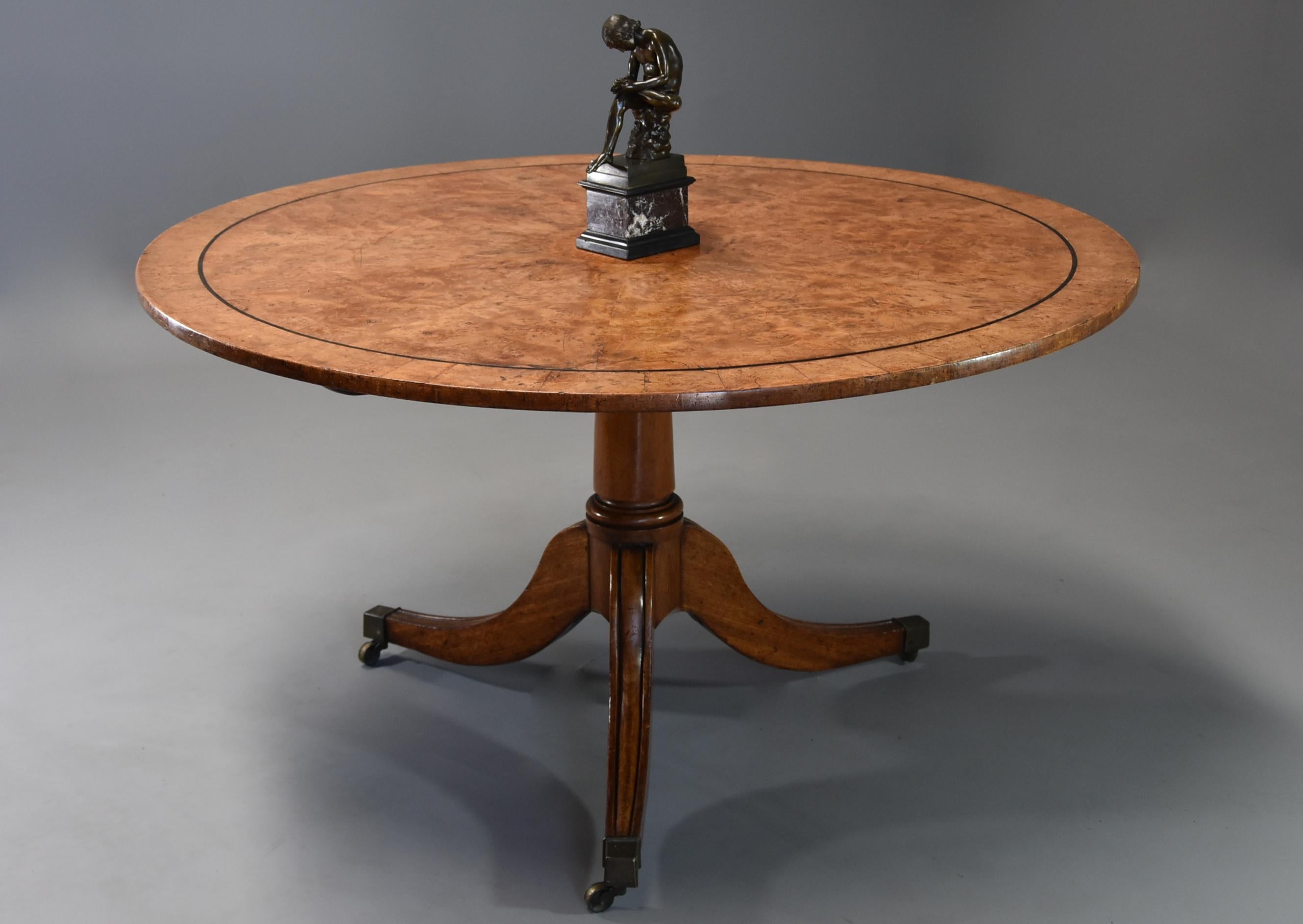 A late 19th century burr elm breakfast table.

This finely figured burr elm table consists of a circular burr elm panel to the centre surrounded by a superbly figured burr elm veneer with an ebonised banding with outer burr elm banding and banded