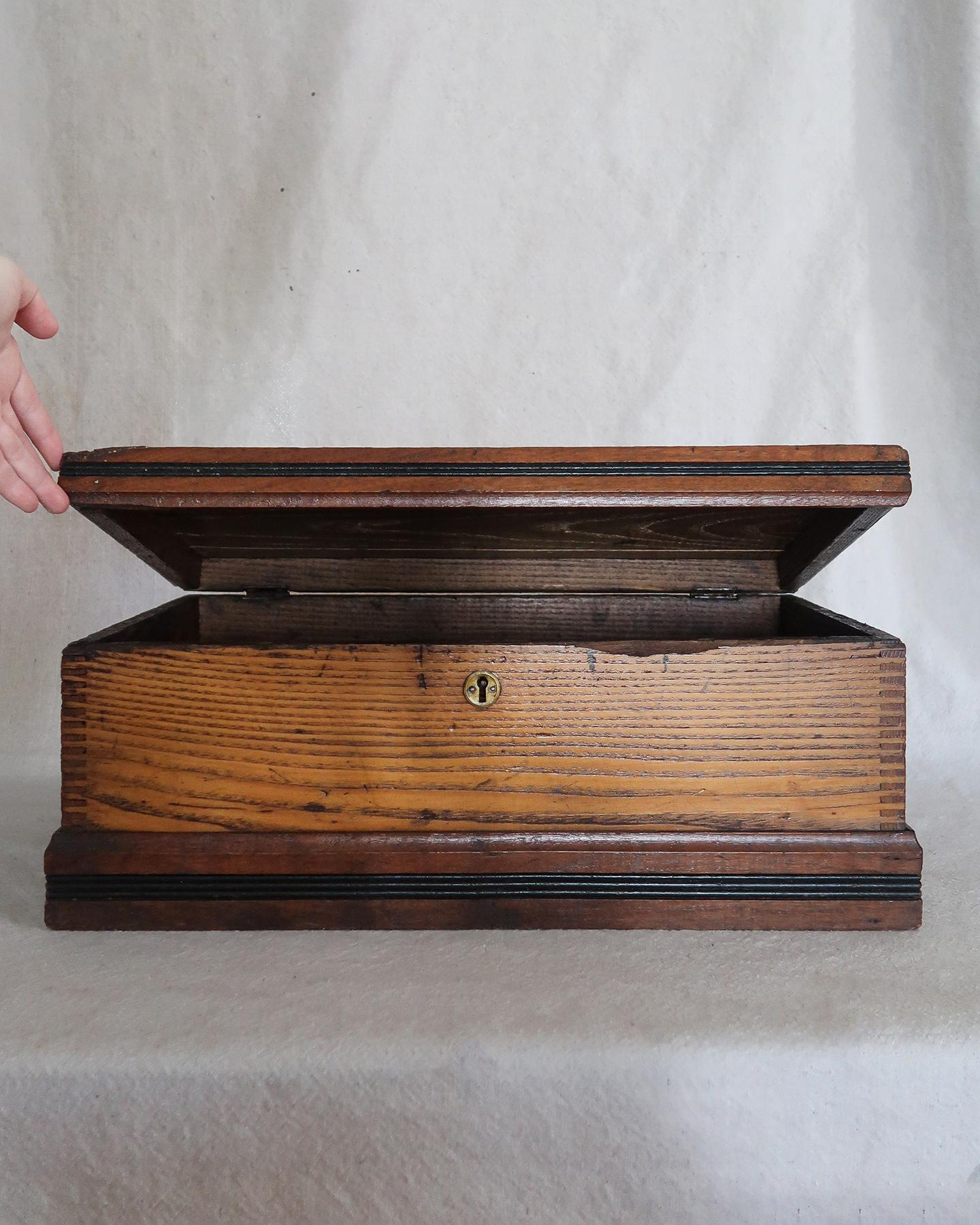 Une boîte honnête avec un peu de drame. Ce coffre de charpentier en chêne de la fin du 19e siècle est une véritable œuvre d'art. Des coins en queue d'aronde, des poignées en fer épaisses et une plaque de serrure en laiton qui a vieilli comme une