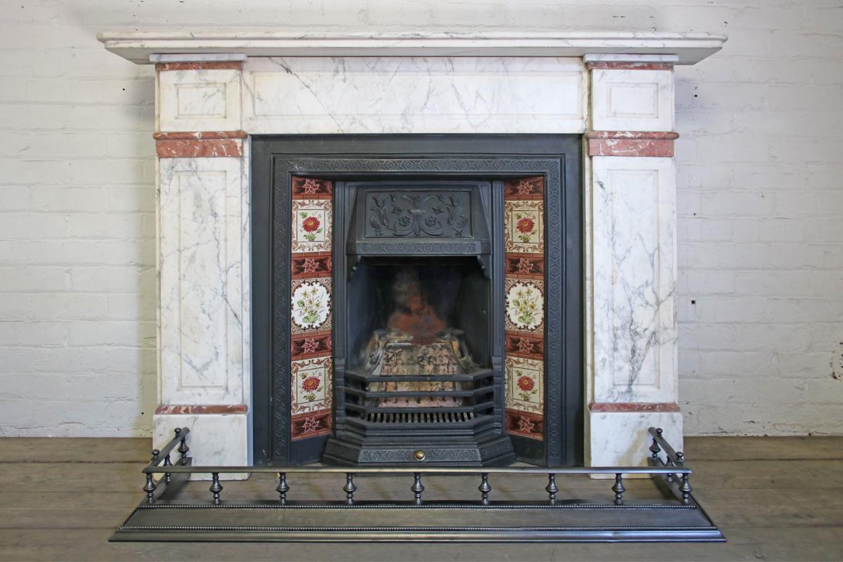 Late 19th century Carrara marble fireplace surround with rouge marble interruptions, circa 1880. 

This surround is currently awaiting restoration, please enquire as to the lead time before placing an order. The price listed is once the fireplace