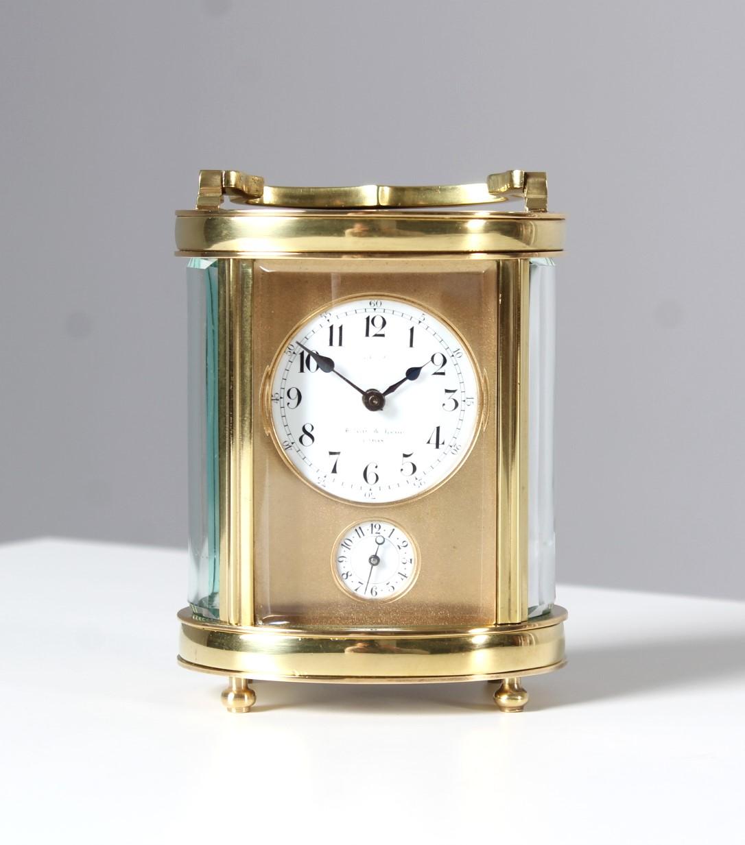 Dimensions: H x W x D: 16 x 9 x 7 cm

The height is measured with handle. Without handle it is 12 cm in height.

Beautiful antique carriage clock or officer's clock.
Rare oval shape. 
Alarm time is set by the lower dial. To wake up the clock strikes
