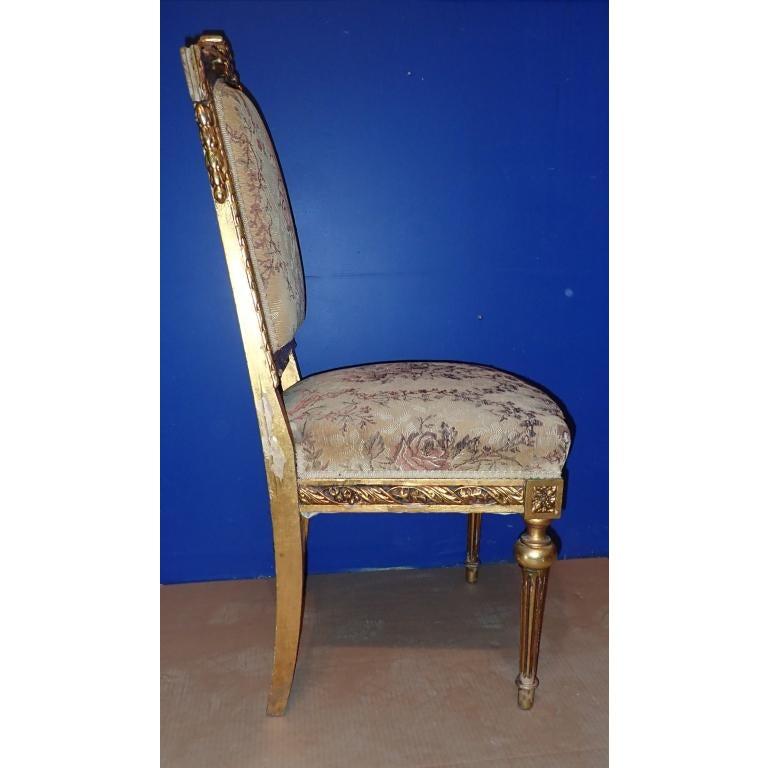 Louis XVI style carved giltwood frame chair with tapestry upholstered seat and back.
Taped column legs. Rosettes and garland decoration. 

Measures: Seat height 17 .0 inches.