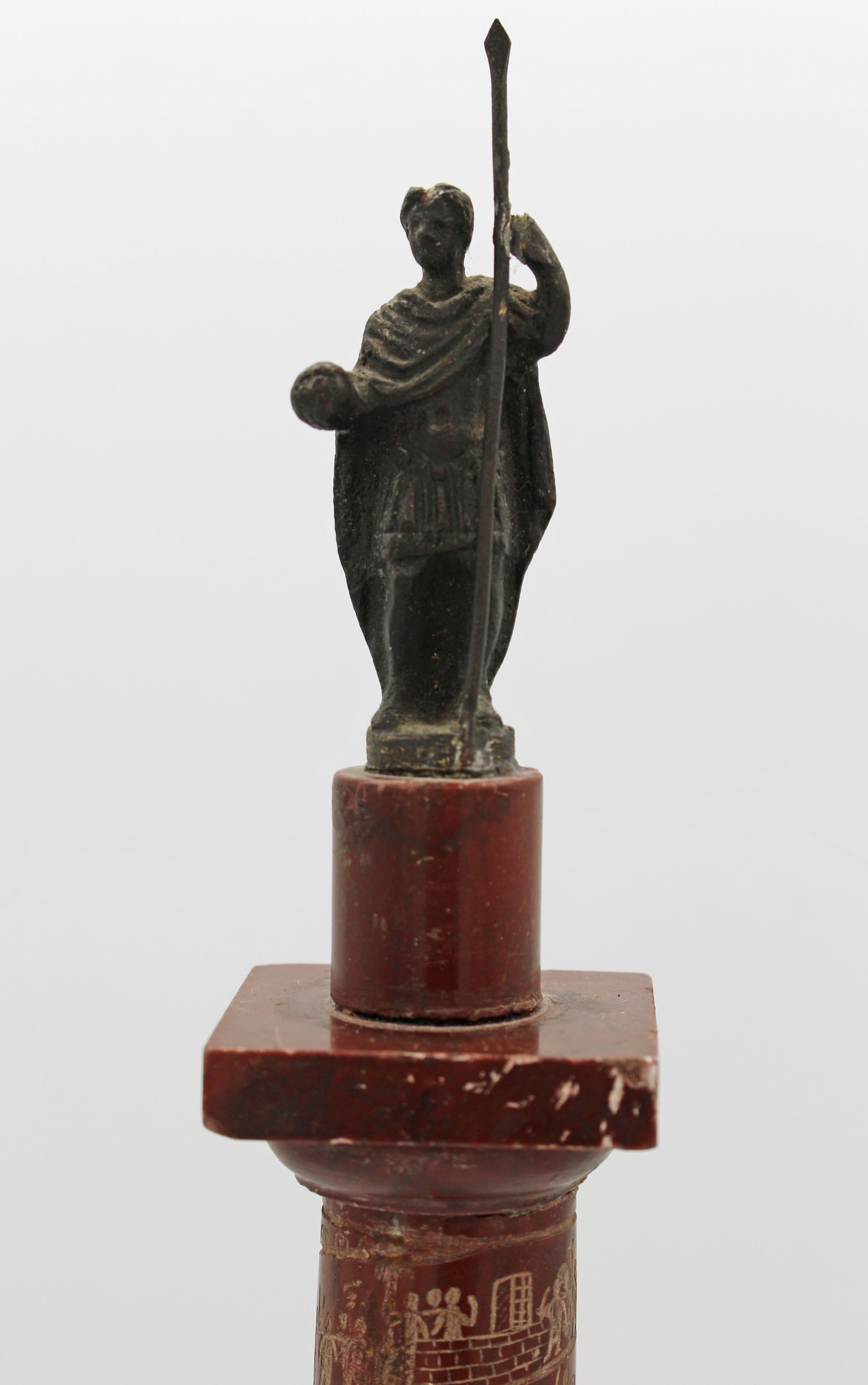 Late 19th Century Grand Tour porphyry craved miniature of Trajan's Column. Finished in AD113, it is crowned with St. Peter (installed in 1587 by Pope Sixtus V). Various Nibbles commensurate with age and material. 15 7/8 h., 2 1/2