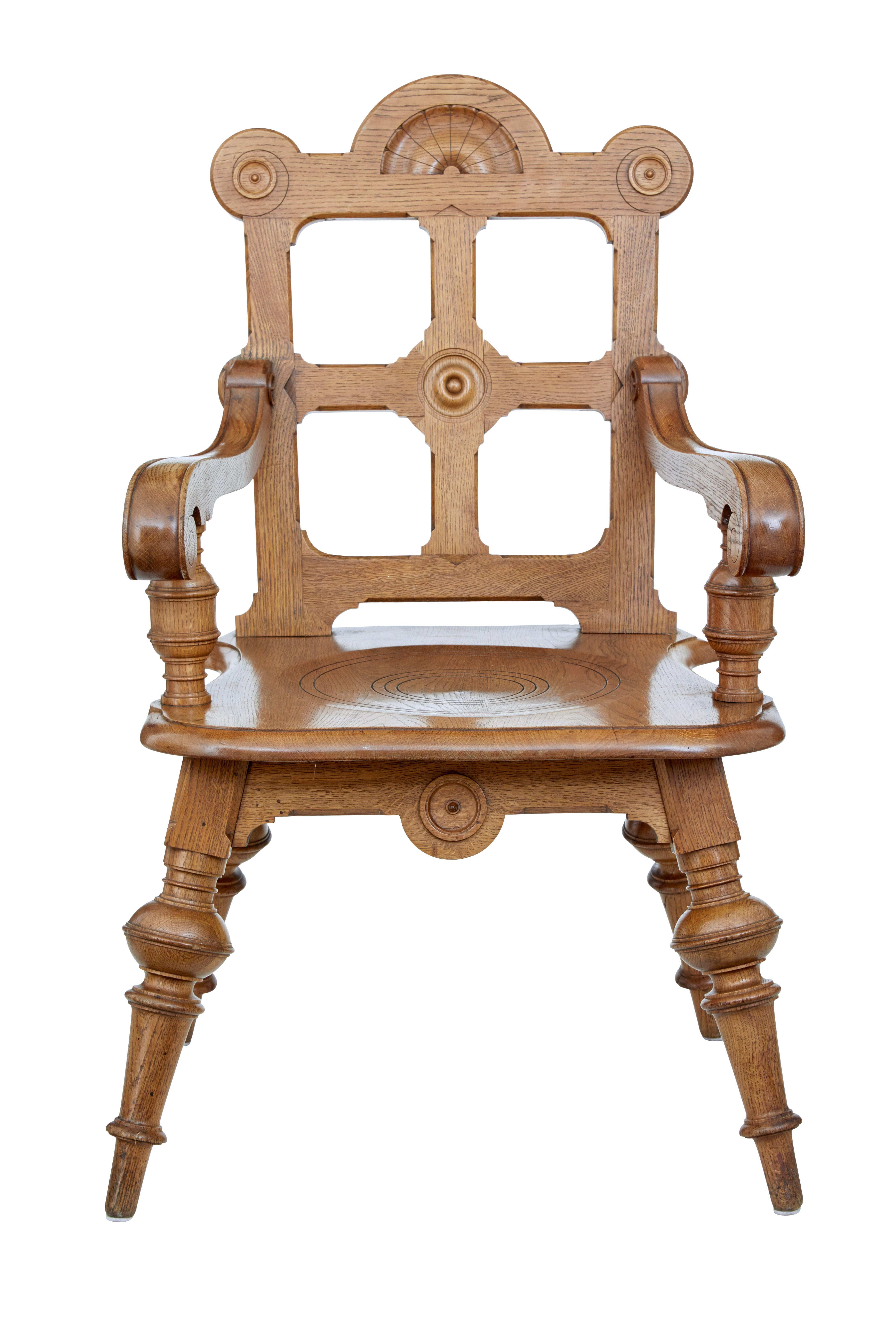 Late 19th century carved oak Arts & Crafts armchair, circa 1890.

Shaped back rest with carved roundels and a central sunburst, link to the scrolled arms and turned supporting column. Seat with circular pattern.

Standing on 4 turned legs. Good
