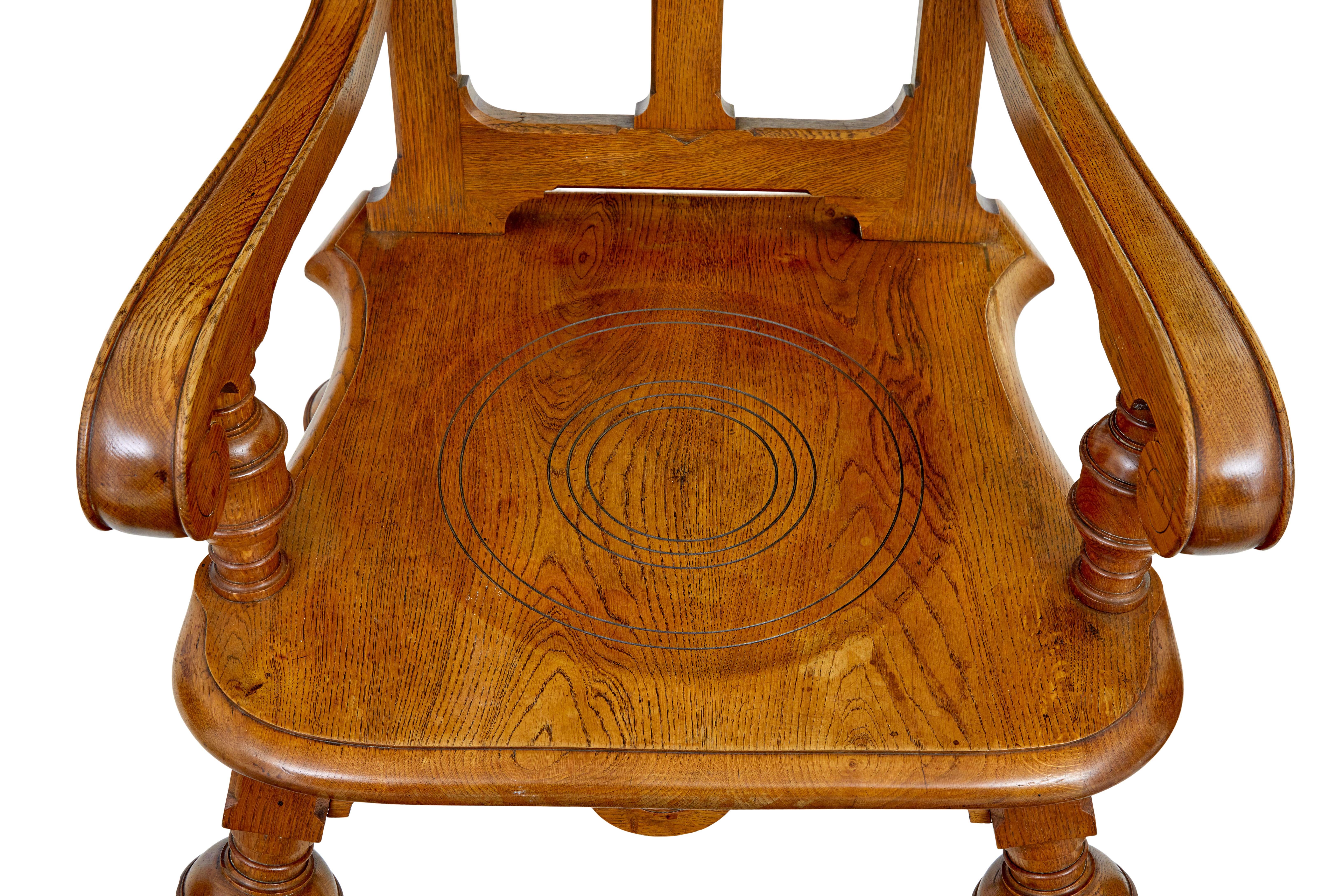 Late 19th century carved oak arts and crafts armchair circa 1890.

Shaped back rest with carved roundels and a central sunburst, link to the scrolled arms and turned supporting column.  Seat with circular pattern, and shaped for further