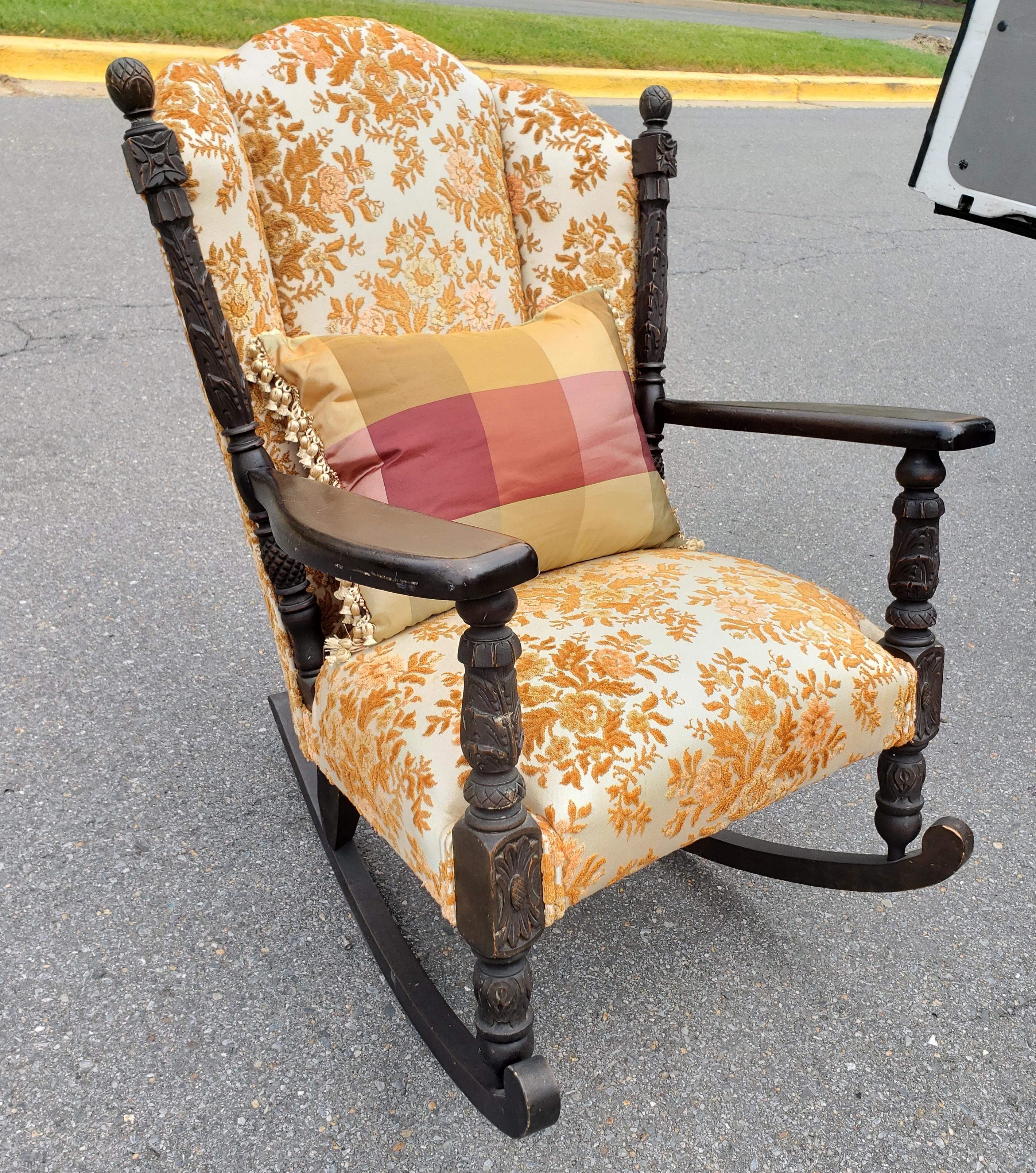 An impresive Late 19th century hand Carved Walnut and Upholstered Rocker. Reupholtered and sold by Alvin Simons.
Come with pillow.