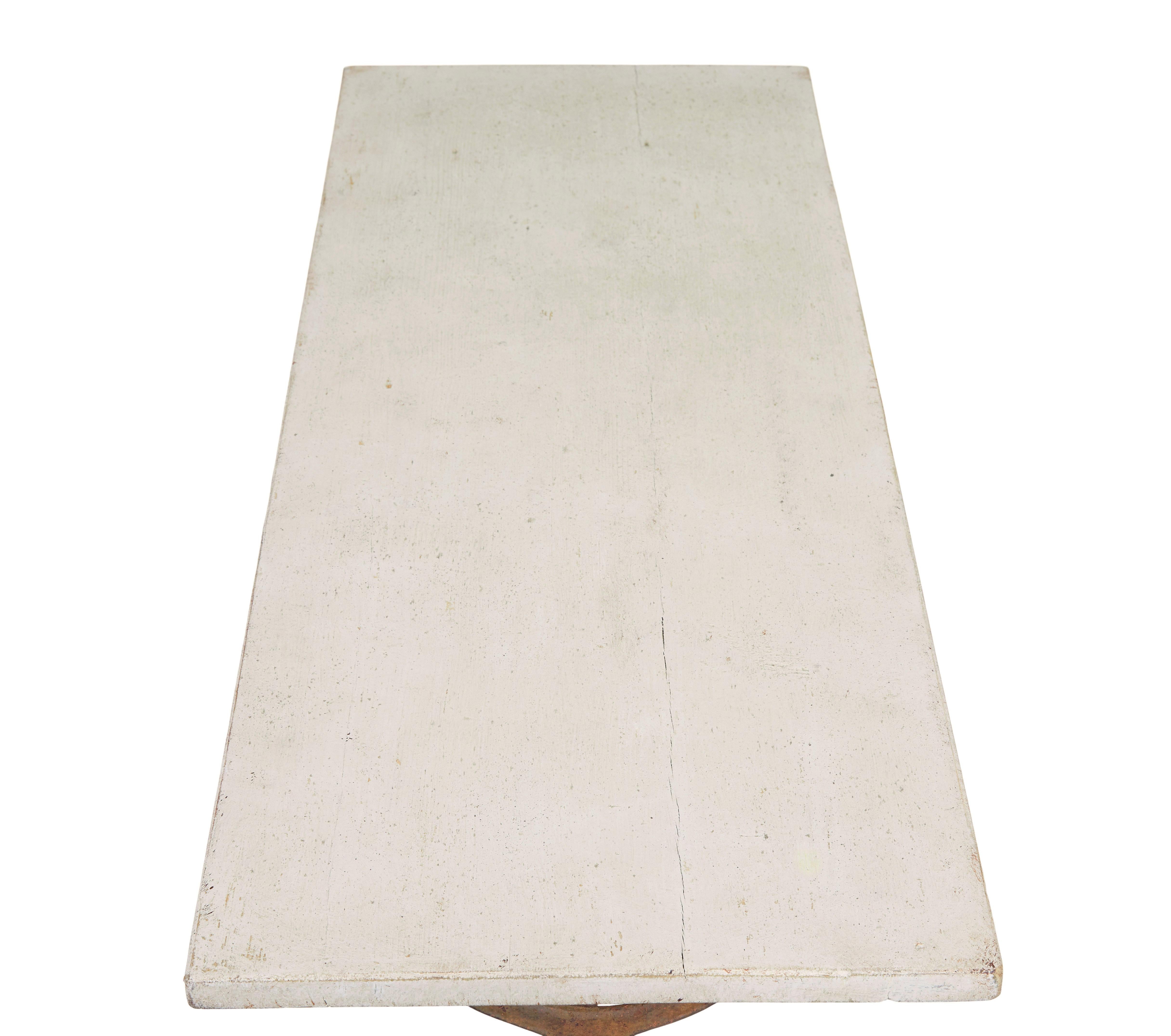 Elegant cast iron side table circa 1890.

Fine table ideal for use as a sofa,side, hall or lamp table.  Ornate base which has taken on a stable rusted appearance with decorative stretcher.  Each standing on a small pad foot.

Pine top hand painted