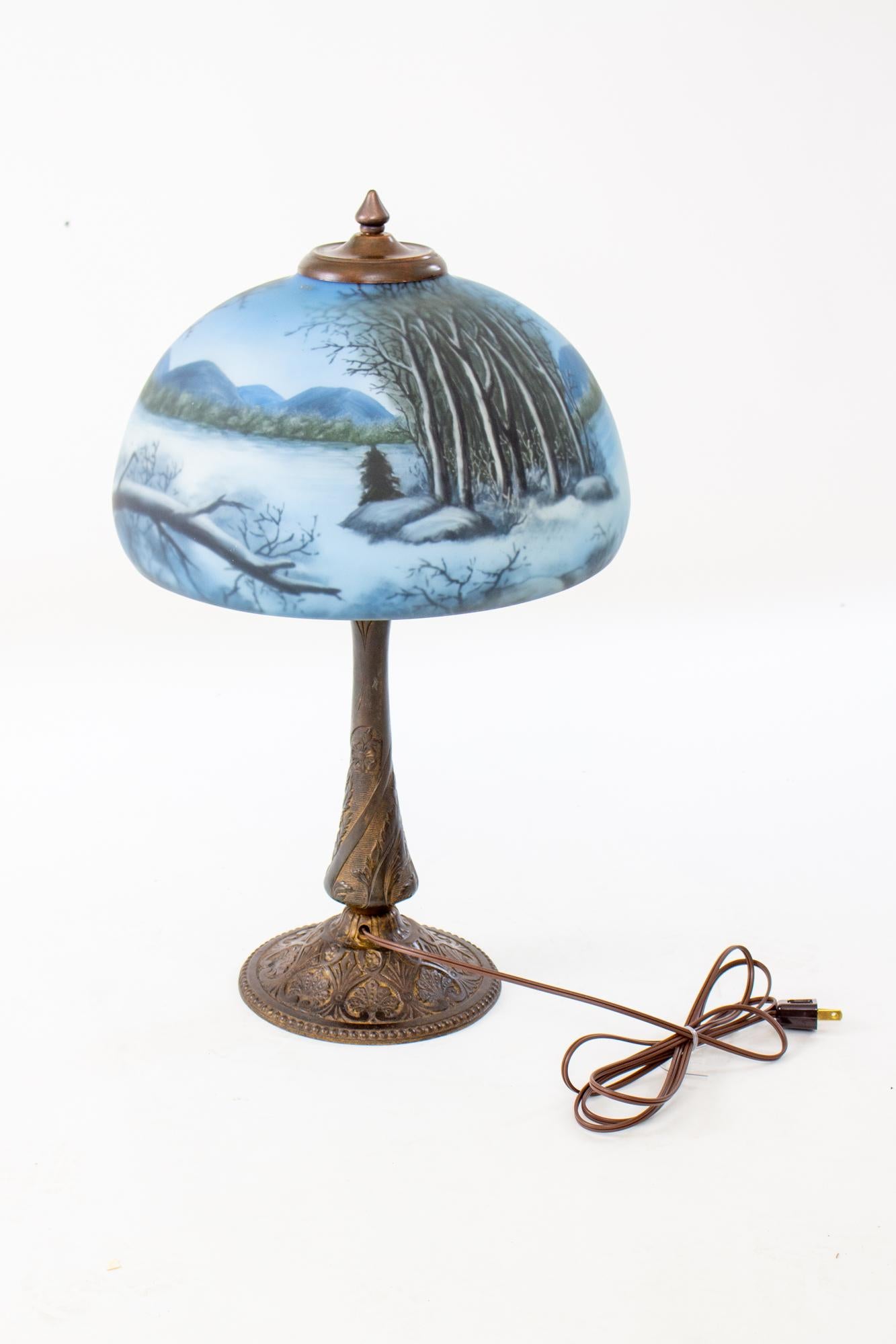 American Late 19th Century Cast Iron Table Lamp with Wintery Blue Reverse Painted Glass S For Sale