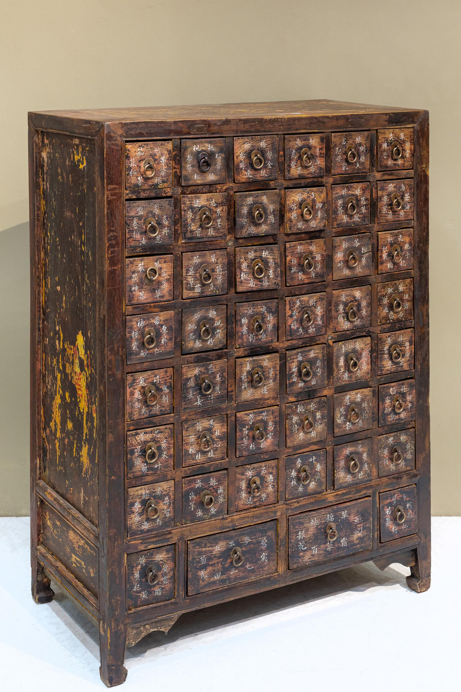 A late 19th century apothecary cabinet from Shanxi province, China, that was used to store and organise Chinese herbs. At some point, yellow paint was applied over the top and sides of the cabinet, and even some red words were written on the sides,
