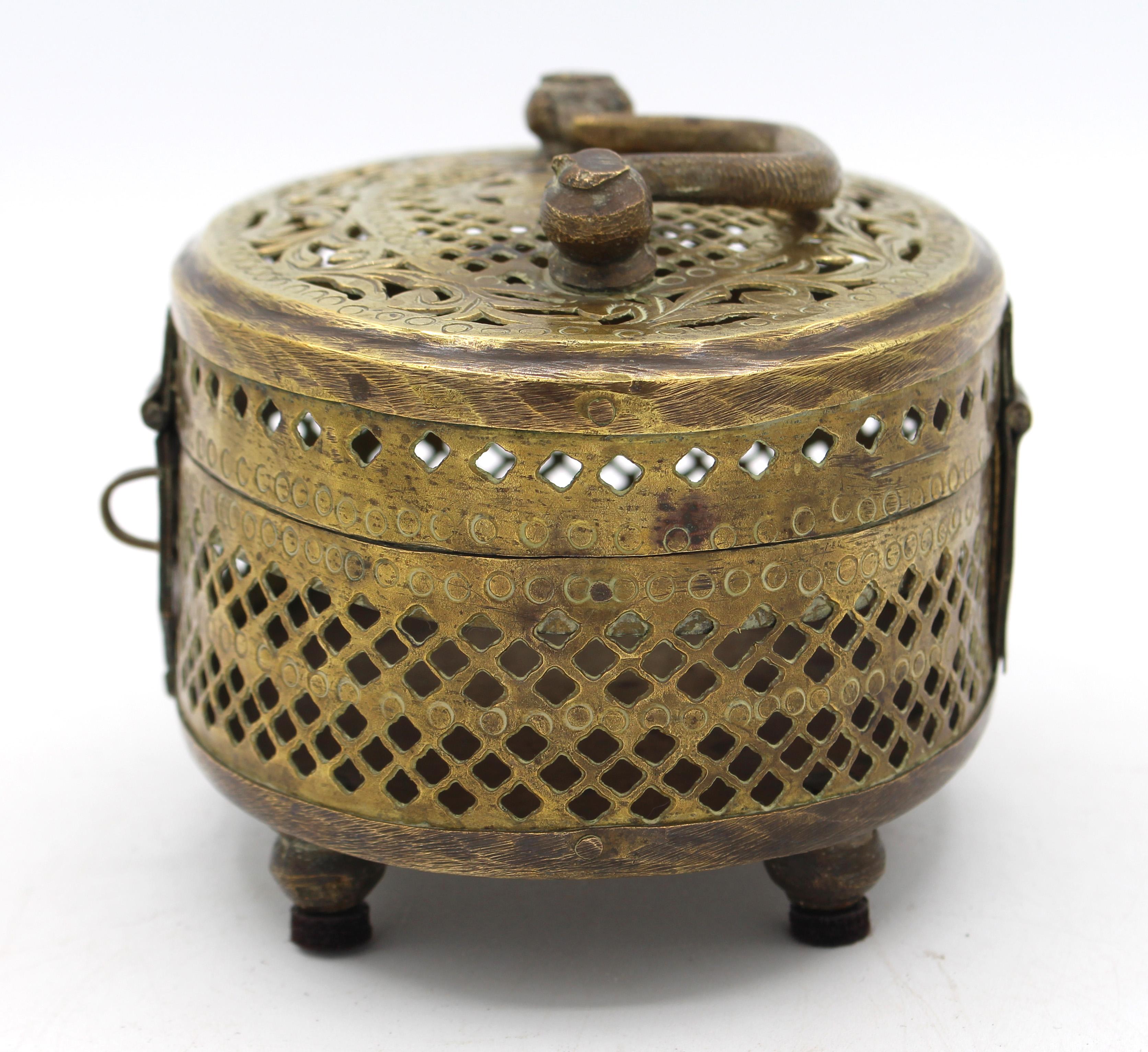Late 19th century Chinese brass cricket box. Elaborately hand cut sides & engraved lid with handle - central floret & swirling leaves. Raised on bun feet.
5