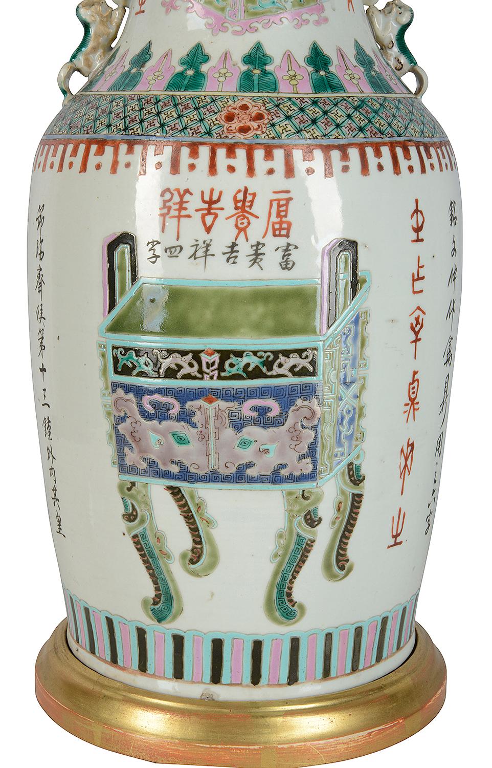 A good quality late 19th century Chinese Famille Verte vase/lamp. Having classical green motif and symbol decoration, mythical dog of faux handles either side. Mounted on a gilded wooden base and lid.