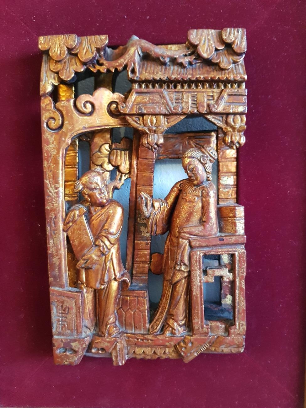 Late 19th century Chinese gilded carved wooden panel depicting 2 people standing in a building, it is framed on red velvet with a gilt faux bamboo frame.

The measurements are incl. frame,
Depth 4.5 cm/ 1.7 inch.
Width 24 cm/ 9.4 inch.
Height