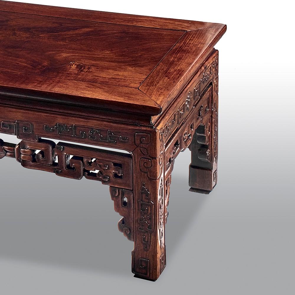 A superb late 19th century Chinese low alter table with an ornately carved apron to the front and the sides.