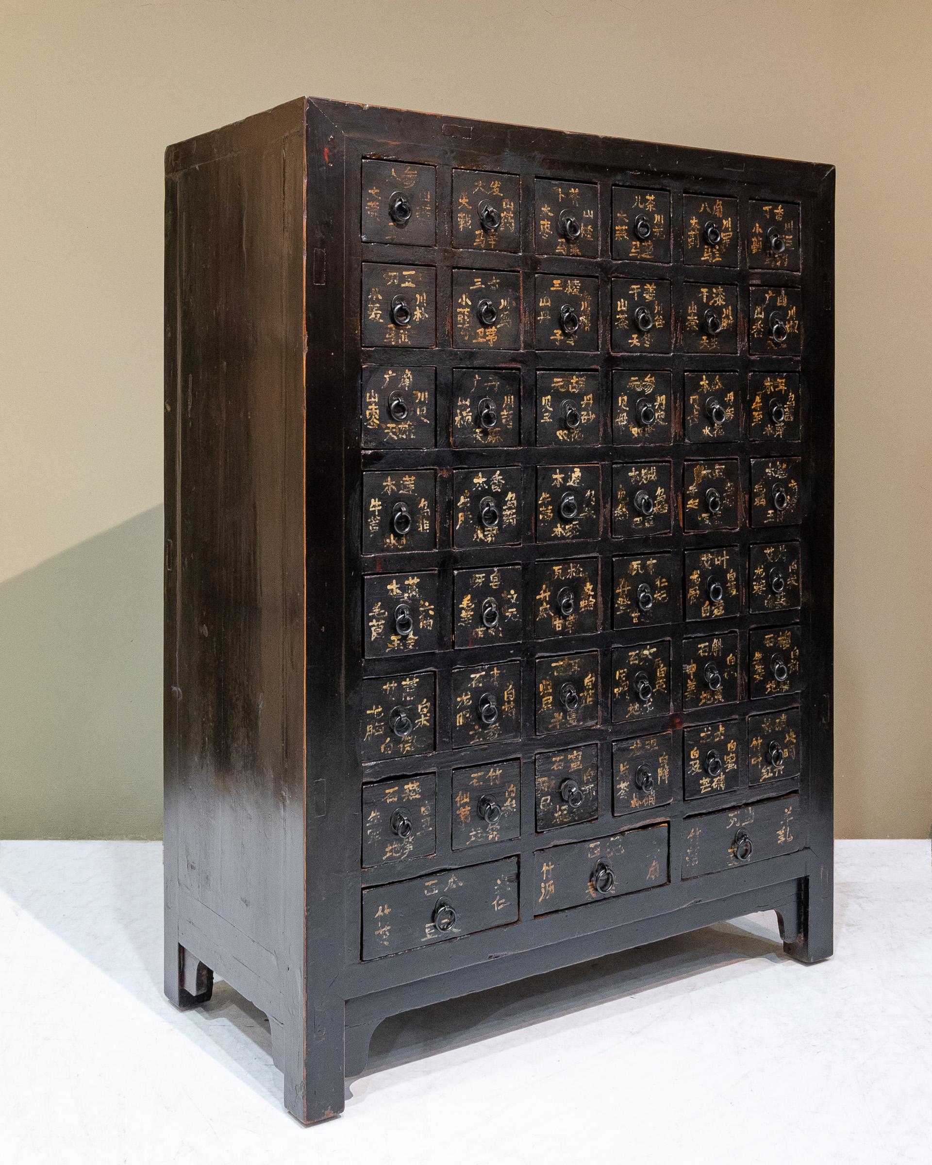 Late 19th century Chinese medicine cabinet from Shanxi province, China. These were used to store and organise Chinese herbs and the handwritten words on the front of the drawers indicate the herbs that were stored in each drawer. Some of the
