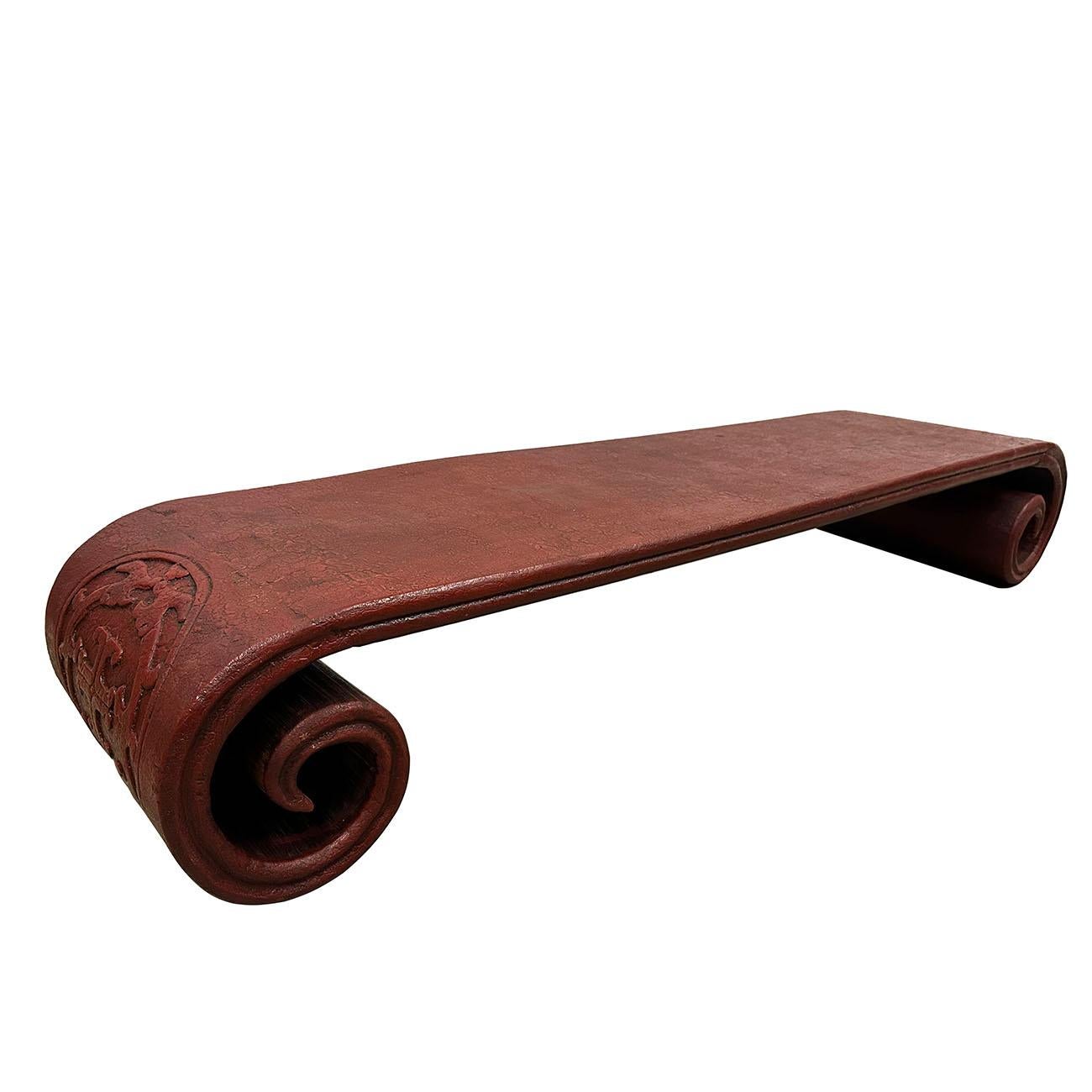 Cette table basse a été fabriquée en orme massif avec une finition laquée rouge. Il a des côtés sculptés en forme de volutes. Tous les produits sont fabriqués et peints à la main. Il est lourd et robuste, plein de patine. Regardez les photos, vous