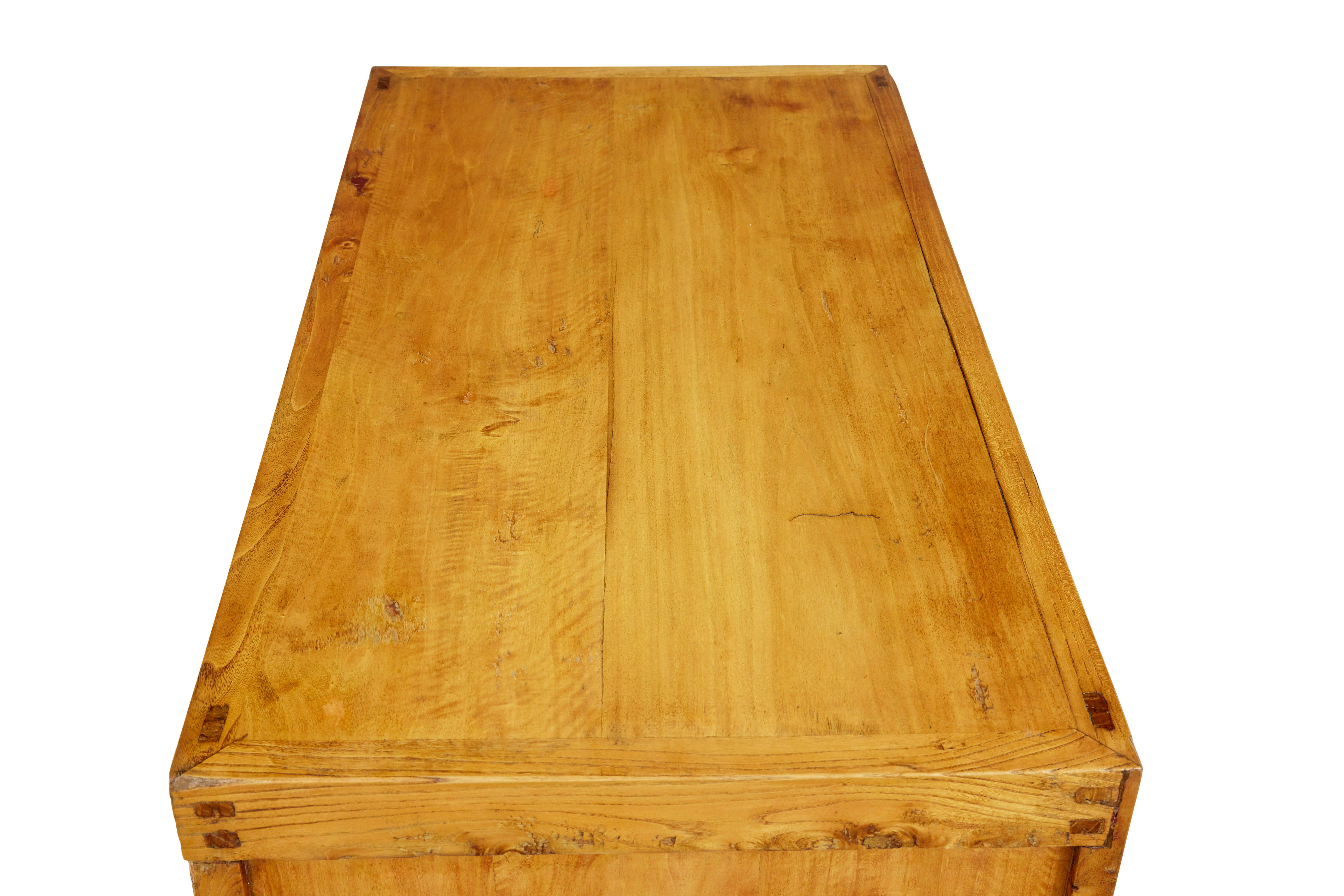 Late 19th century Chinese small sideboard circa 1890.

Made from from oriental softwood, with 3 drawers below the top surface and a double door cupboard below.  Original hardware.  Displaying evidence from the interior to have been previously red