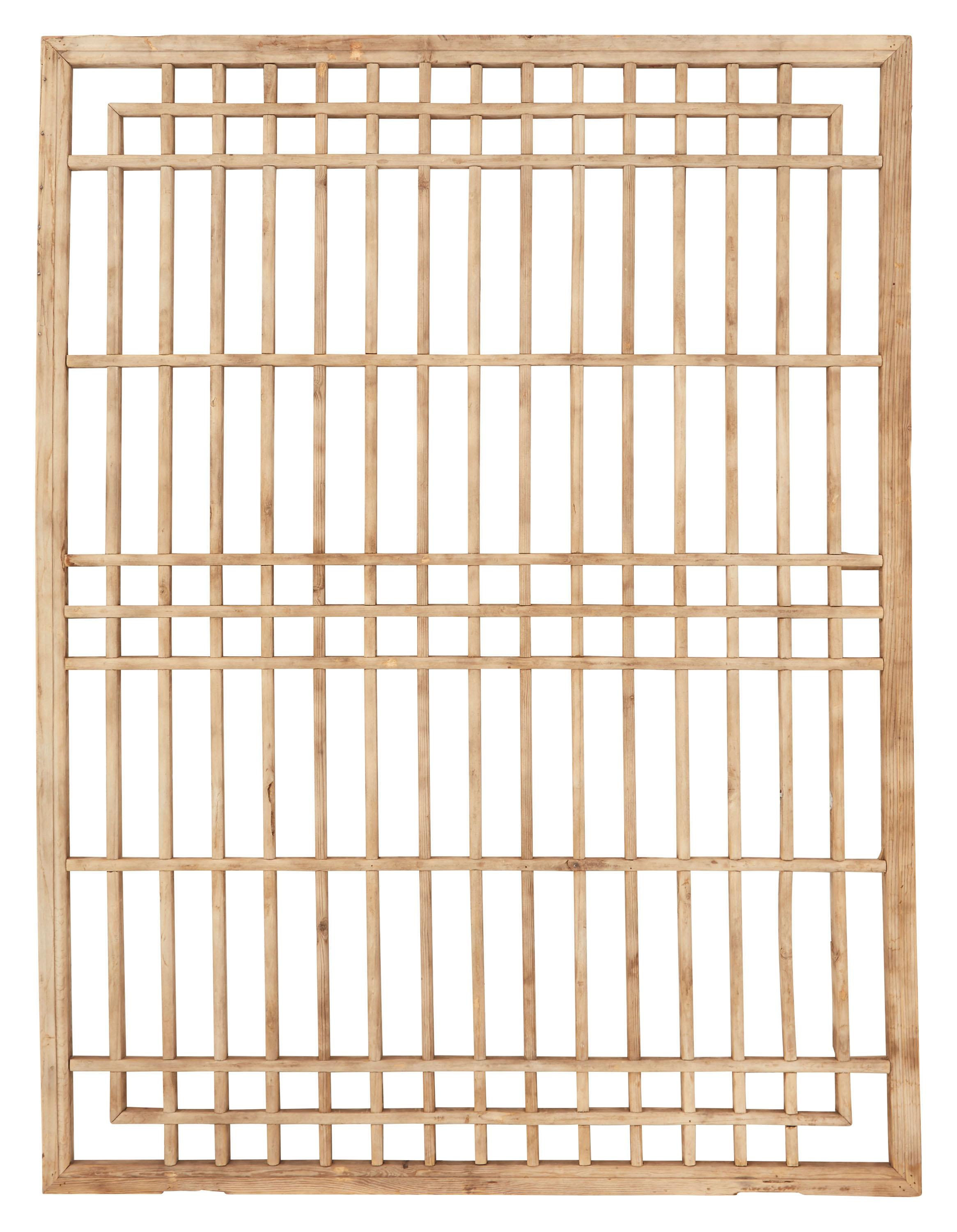 Our vintage elm screen was made in China sometime in the late 19th century. Commonly used as a window covering in homes across the country, this intricate lattice-work shutter was originally paired with a thin rice paper panel in the summer months