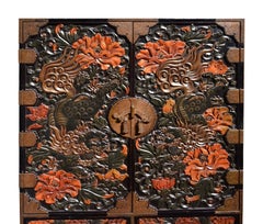 Late 19th Century Chinoiserie carved Lacquer cabinet on stand.