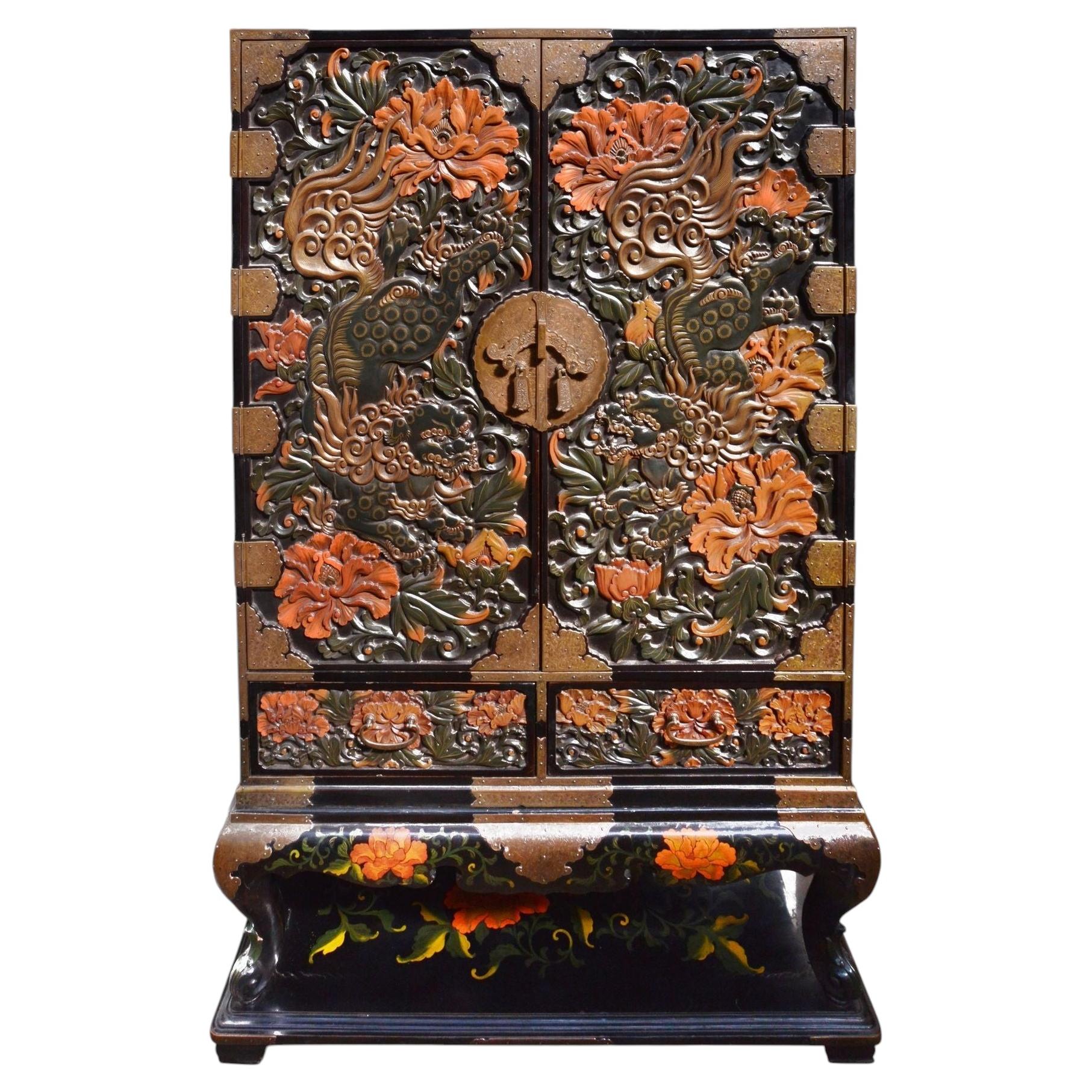 Late 19th Century Chinoiserie carved Lacquer cabinet on stand.