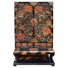 Late 19th Century Chinoiserie carved Lacquer cabinet on stand.