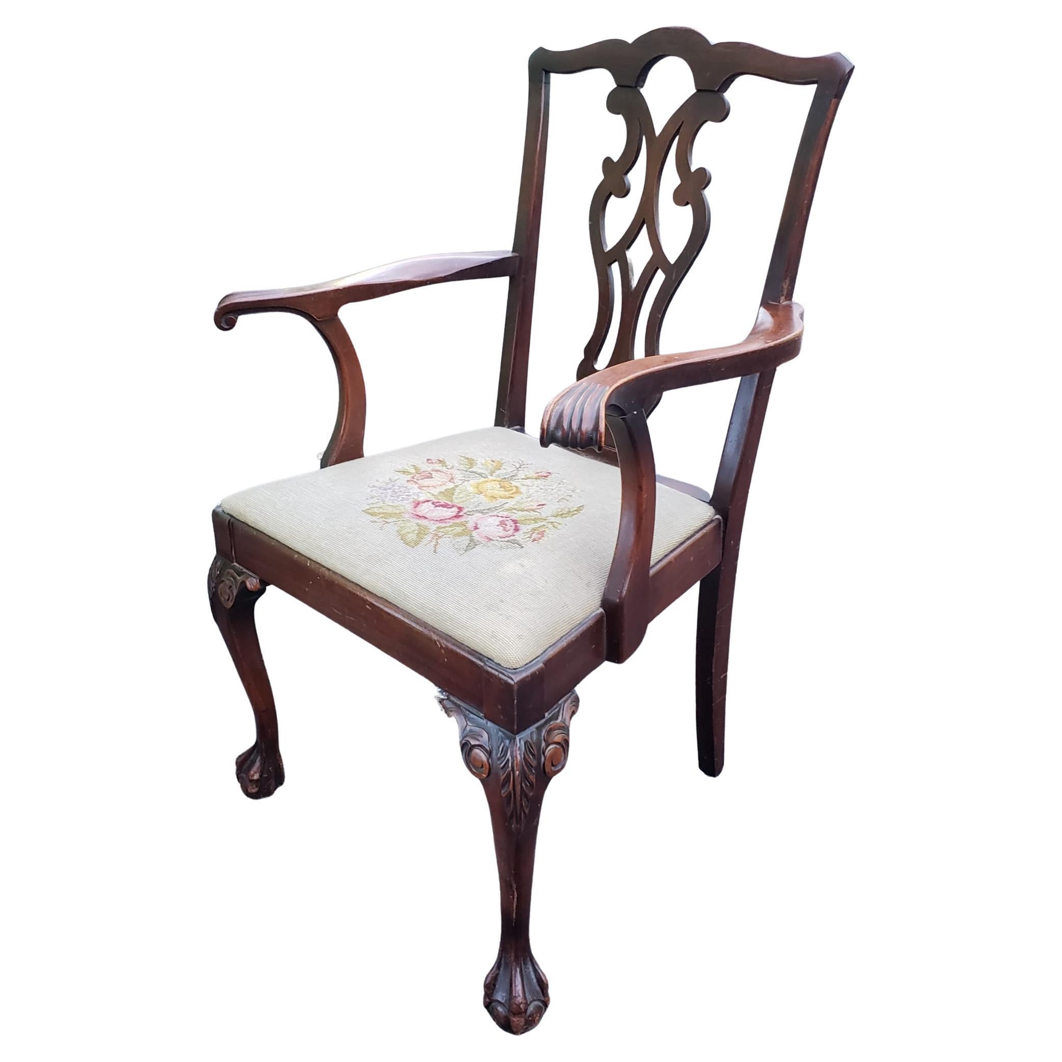 Late 19th Century Chippendale mahogany needlepoint Upholstered armchair with carved cabriole legs terminating with ball and claw feet. Measures 26