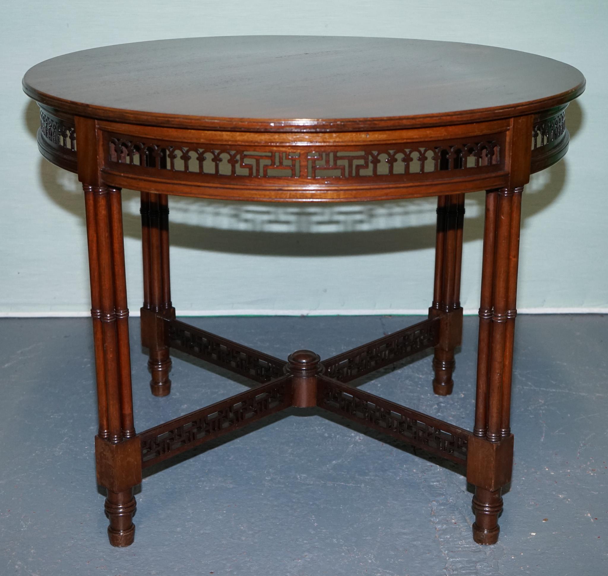 
Antiques of London



An elegant late 19th-century Chippendale-style round occasional table, crafted in rich, warm-toned wood and showcasing exceptional attention to detail. The pierced fretwork gallery apron encircles the round top, while the base