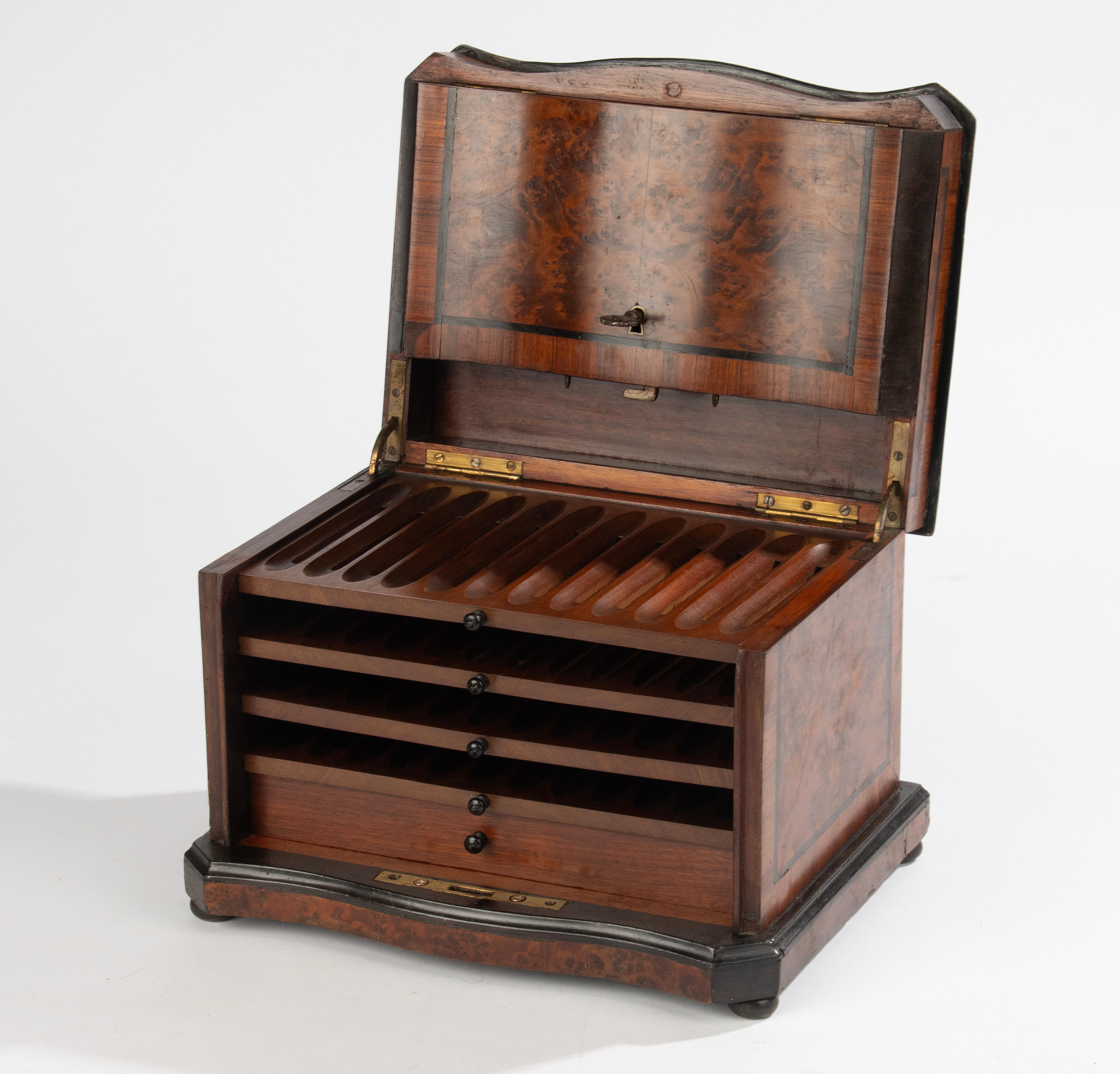 A beautiful antique cigar box, from France, from the Napoleon III period, circa 1880.
The box is veneered with warm red burl wood.
A copper emblem in the center of the lid (which can possibly be engraved).
The chest has 4 drawers for cigars, 12