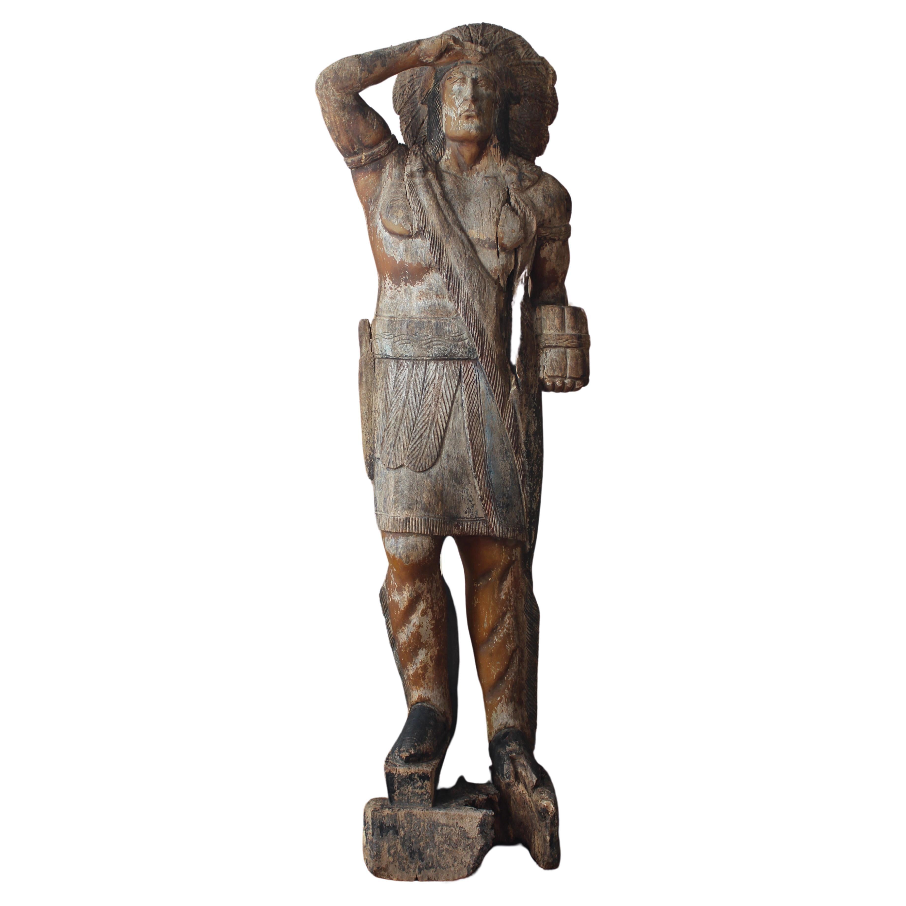 A life size carved pitch pine cigar/tobacconist trade sign/point of sale in the form of an Indian. Often placed outside of a shop, the cigar store Indian became less common in the 20th century for a variety of reasons. Sidewalk-obstruction laws