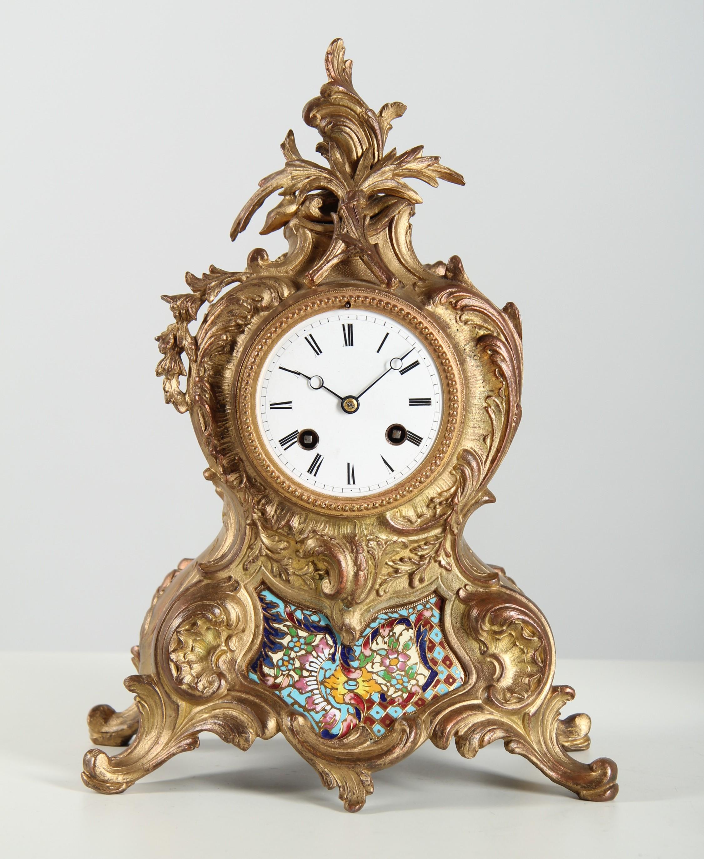 French mantel clock with cloisonné inlays

Paris
Gilt bronze, enamel, movement by E. Gaillot, Paris
c. 1880

Dimensions: H 32 × W 23 × D 15 cm

Description:
Elaborately designed mantel clock in gilt bronze with finely modelled rocaille ornaments.