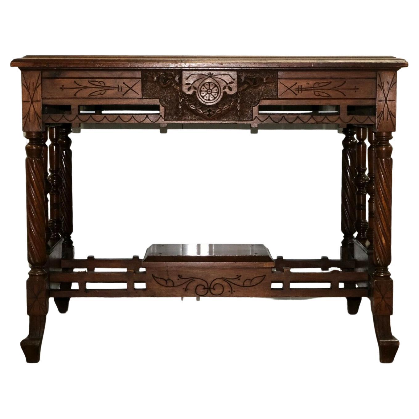 We are delighted to offer for sale this charming 19th century carved walnut writing table with leather inset top.

This table has beautiful carvings all around, making it very elegant and eye catching for any room. The spiral fluted legs and