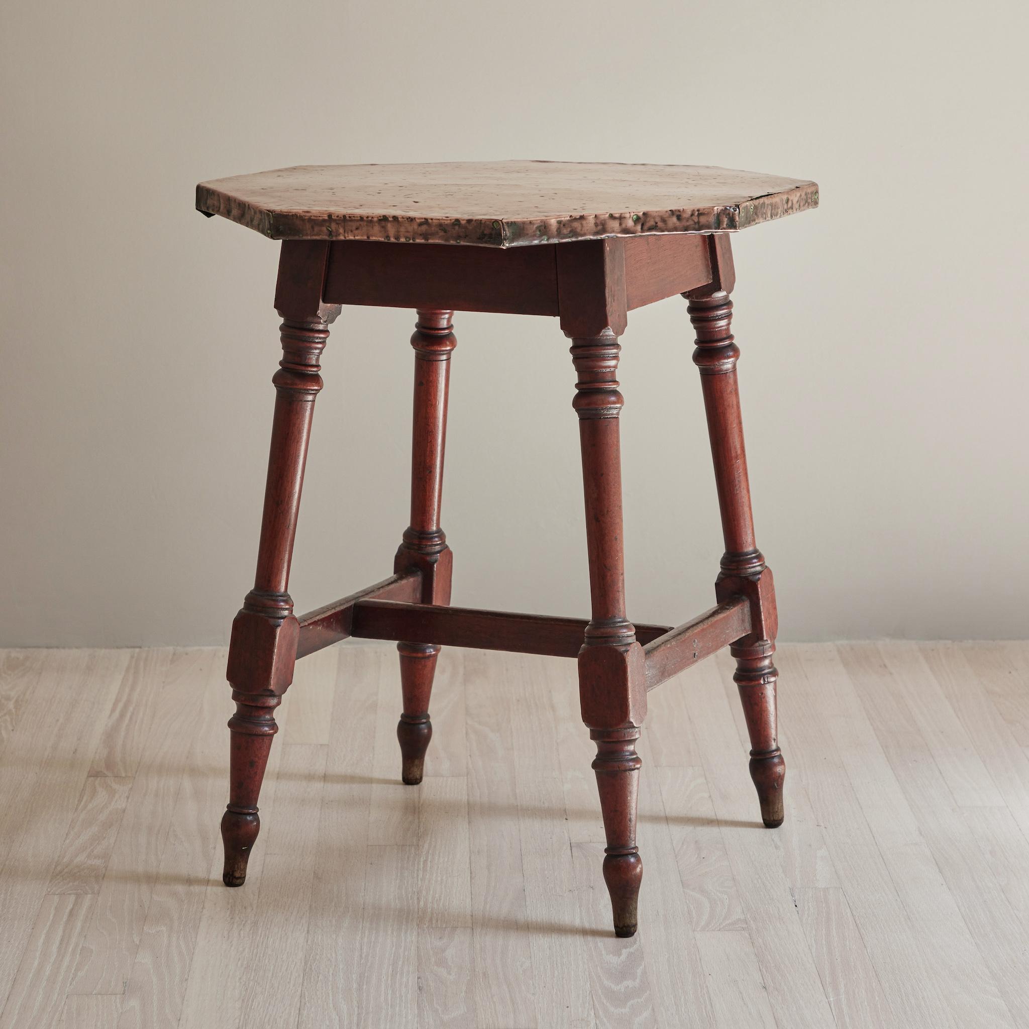 Late 19th century copper top side table with wooden legs from England. 