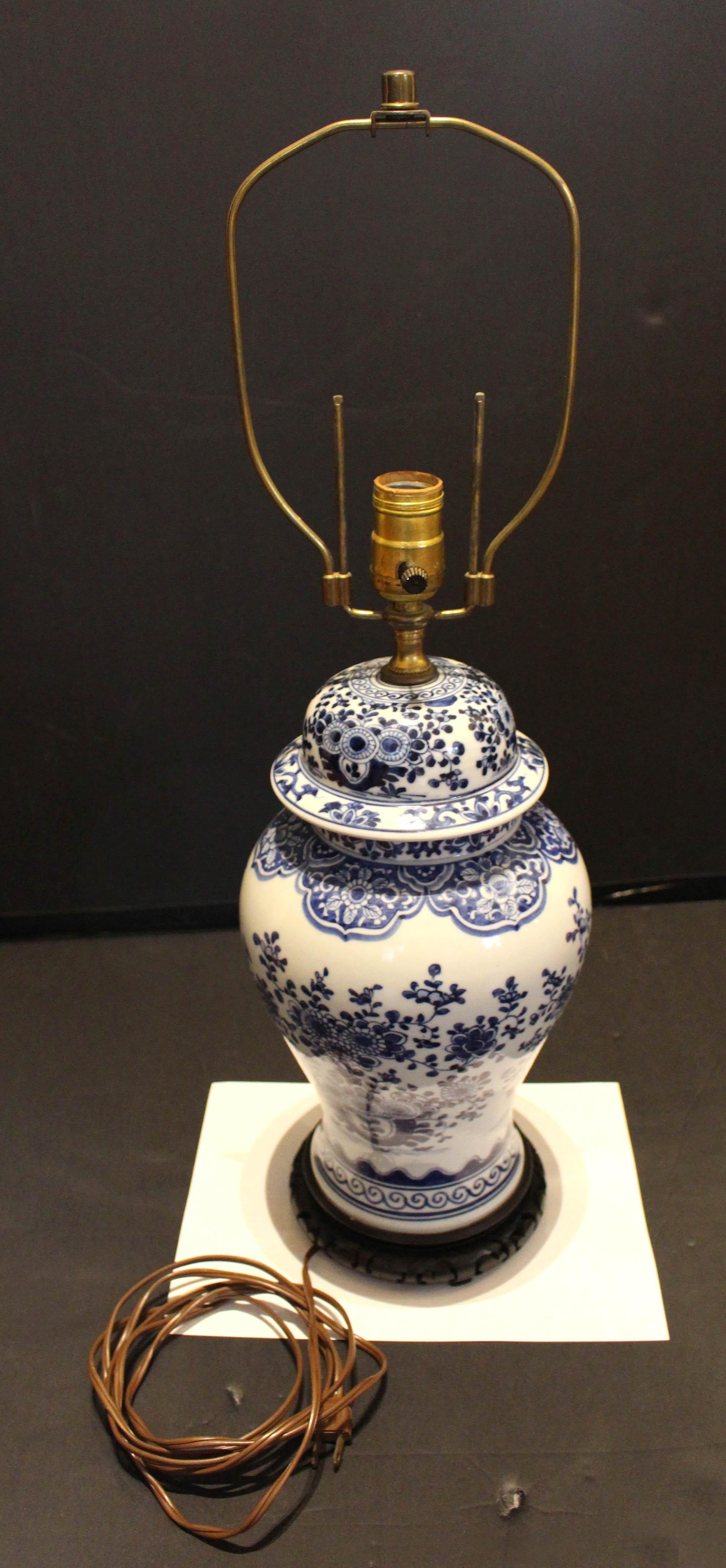 Late 19th century covered ginger jar lamp, Chinese. Blue & white porcelain. Likely made into a lamp in the mid 20th century. Attractive baluster form, well decorated with large potted flowering trees & naturalistic motifs.
19.25