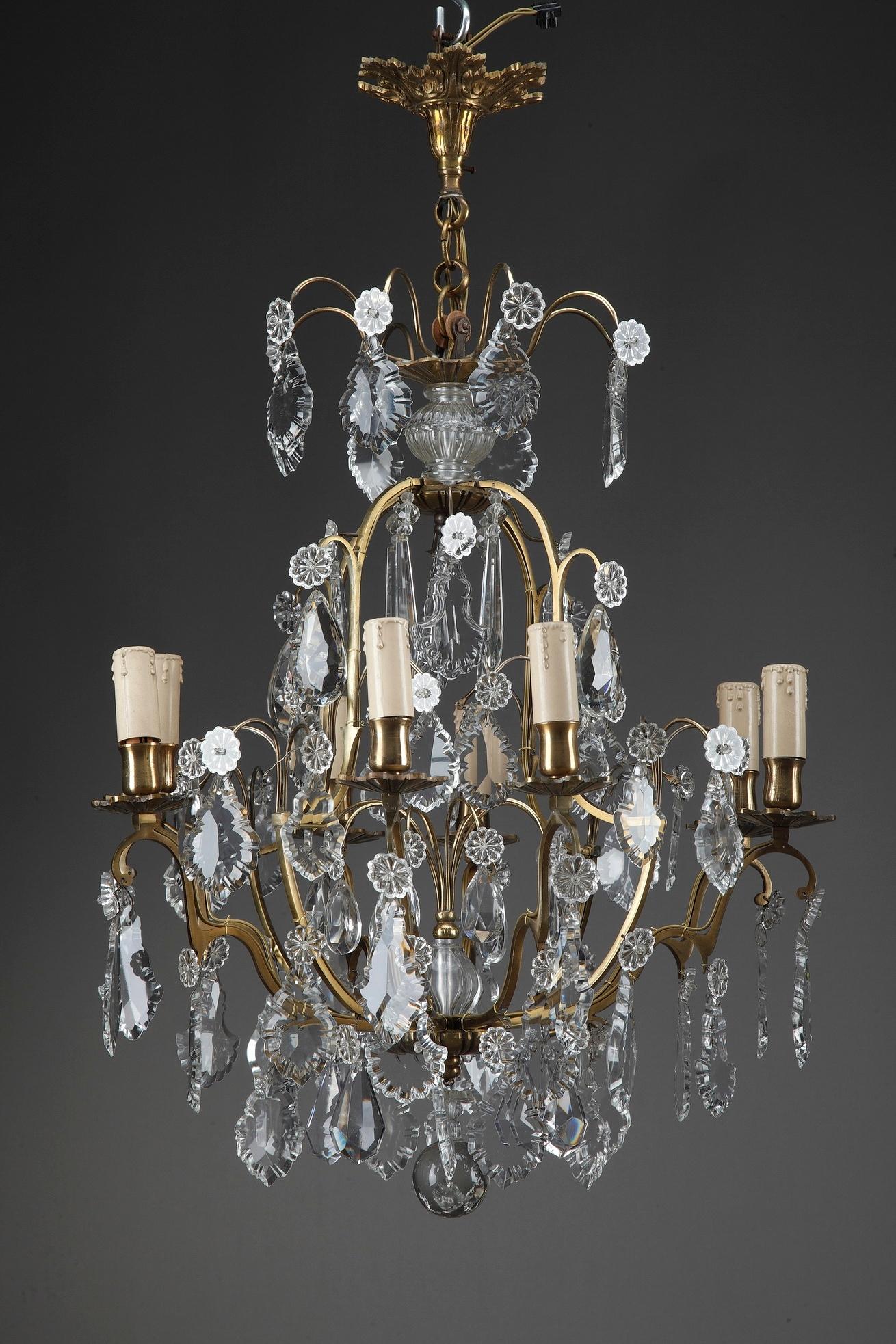 Pair of 8-light antique French chandeliers featuring floral motif and oversized drops of crystal. The eight lights of this fixture are supported by scrolling branches cast in ormolu or gilt bronze. Late 19th century period,

circa