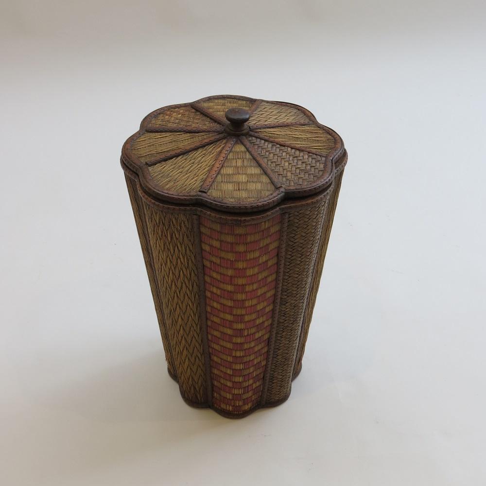 A late 19th century or early 20th century hand crafted lidded bin or container. Made from decorative straw work panels and carved fruit wood mouldings with a turned wooden knob to the top of the lid. The interior of the bin is lined with plywood.