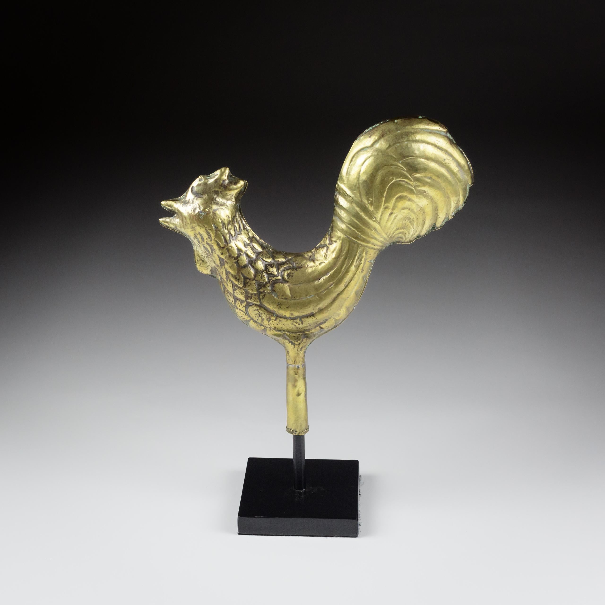 Diminutive Full Bodied Cockerel Weathervane. Utterly Charming, likely from a Chicken Coop or smaller outbuilding.
Polished.
France, Brass.
Circa 1880. 
Later Museum Stand.