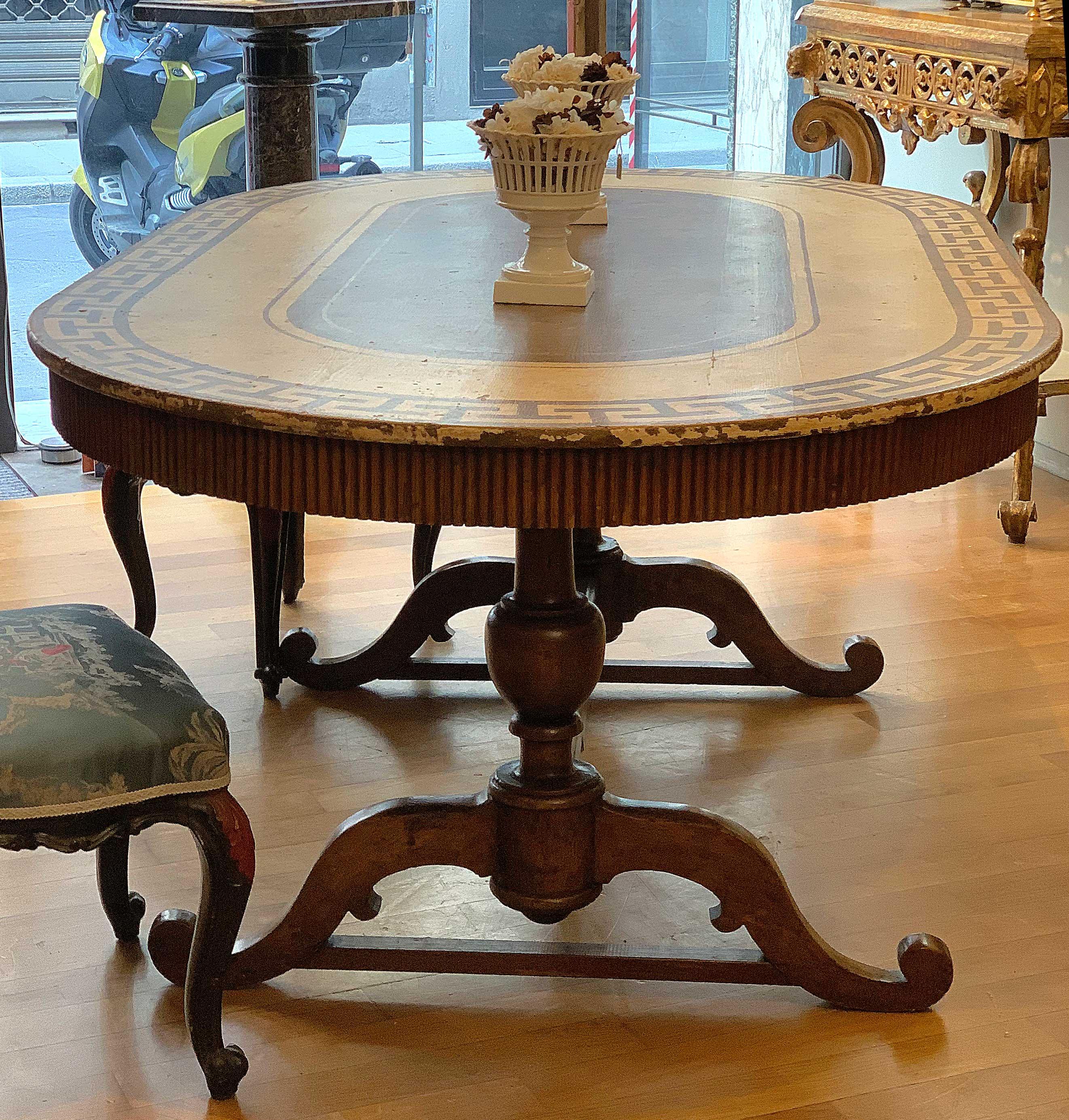 Beautiful neoclassical table with base in walnut formed by two amphorae joined by a crossbar, top in spruce wood painted with lean tempera with paraffin finish. It recalls the English neoclassical style and belongs to some Tuscan cabinet makers who