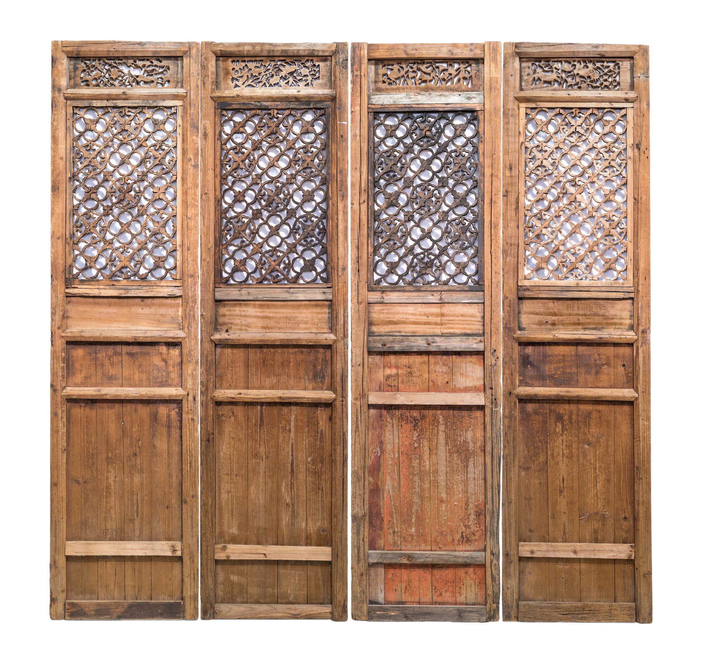 Late 19th century door panels with lattice patterns and carvings from Jiangxi province, China.
This set of doors have a very beautiful and highly unusual lattice pattern. Besides the floral elements, there are also cloud motifs embedded amongst the