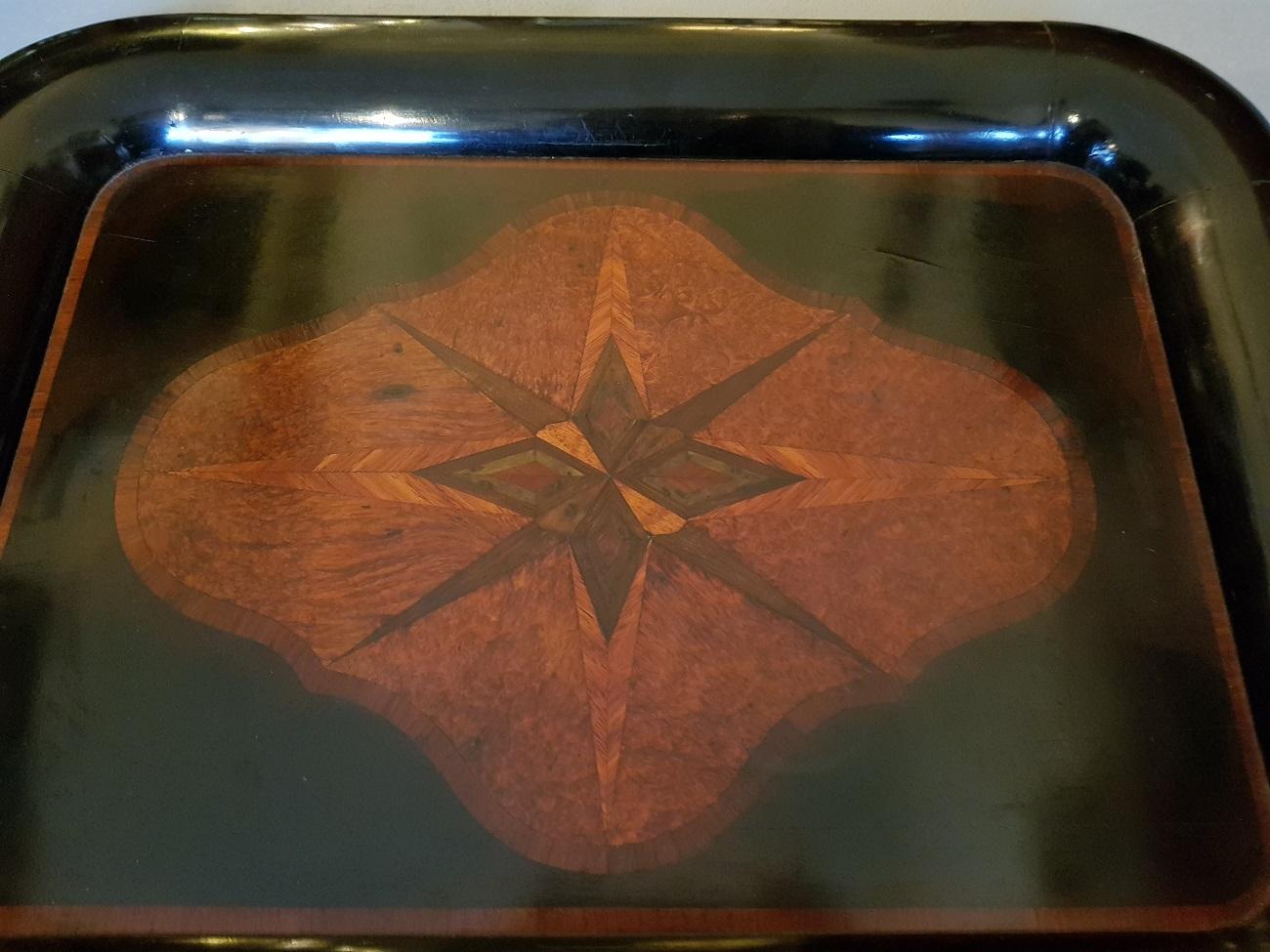Late 19th century Dutch black polished serving tray inlaid with various woods (wear consistent by age and use).

The measurements are,
Depth 40 cm/ 15.7 inch.
Width 52 cm/ 20.4 inch.
Height 3.5 cm/ 1.3 inch.