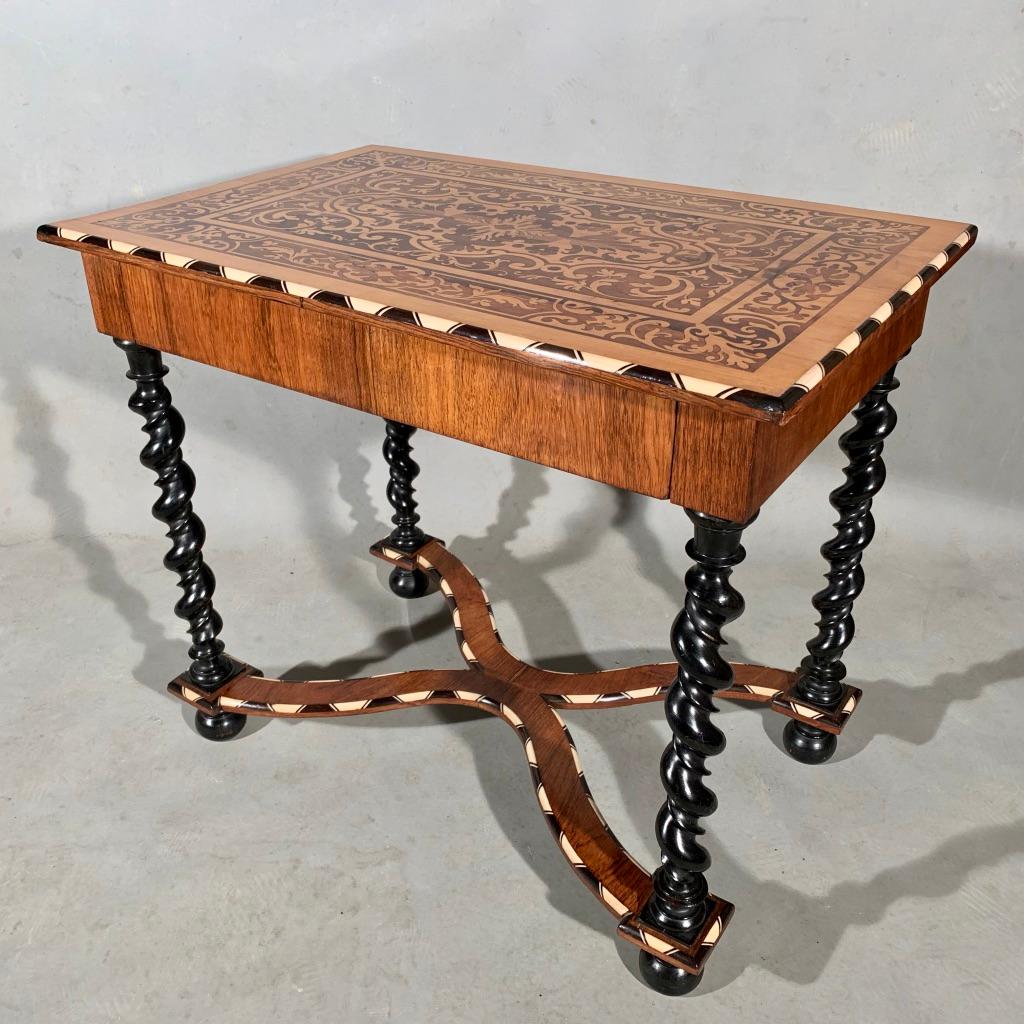 Stunning late 19th century Dutch marquetry with bone and ebony inlay side table or lamp table with ebonised barley twist column legs and this lovely cross stretcher with further bone and ebony inlays.

The table has a full width drawer which is