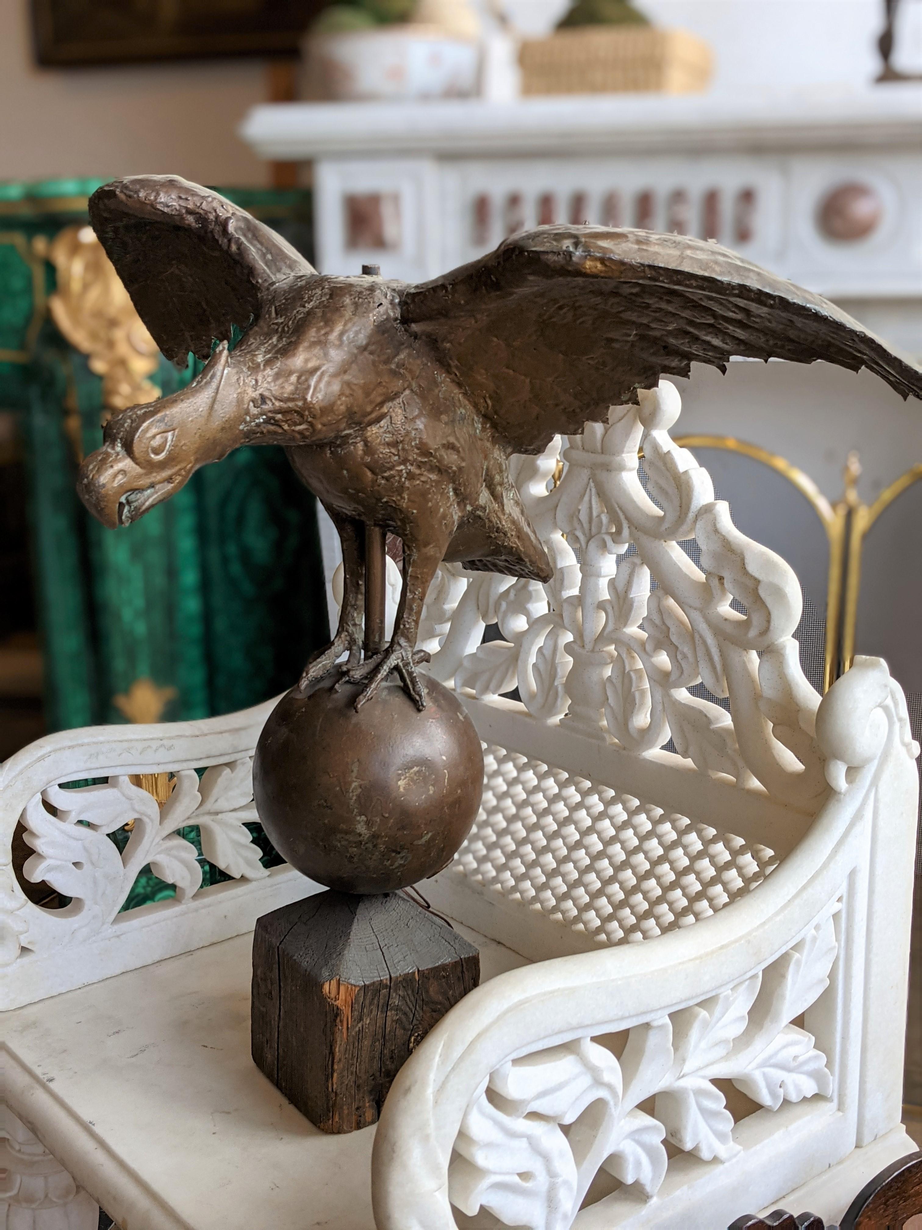 Late 19th Century American painted copper eagle weathervane with wings raised standing on orb.

Laer wood base.