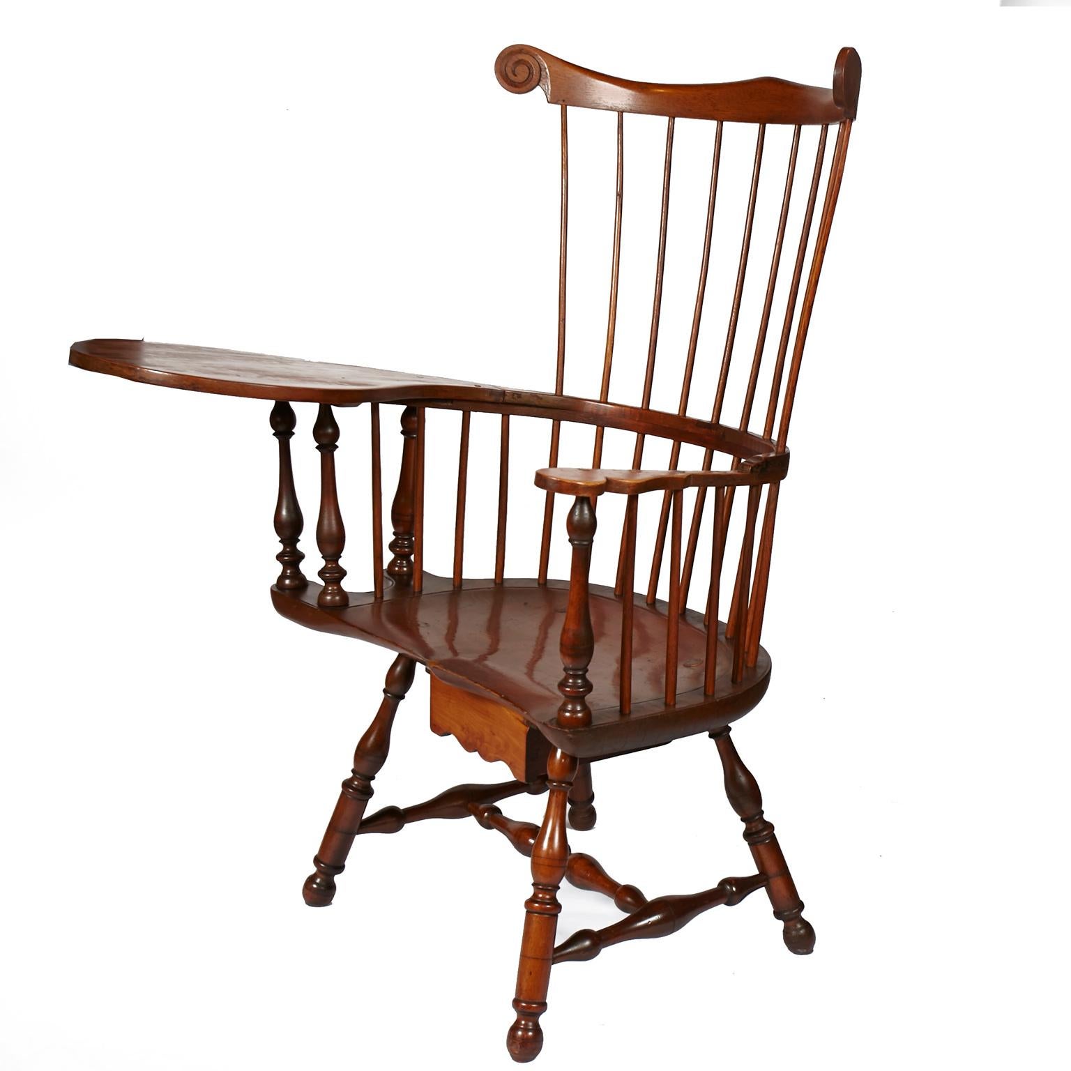 Professionally restored late 19th-early 20th century American Colonial revival, windsor writing armchair. Retains it's original patina. Structurally sound. One drawer under seat. A statement piece for any interior.
 