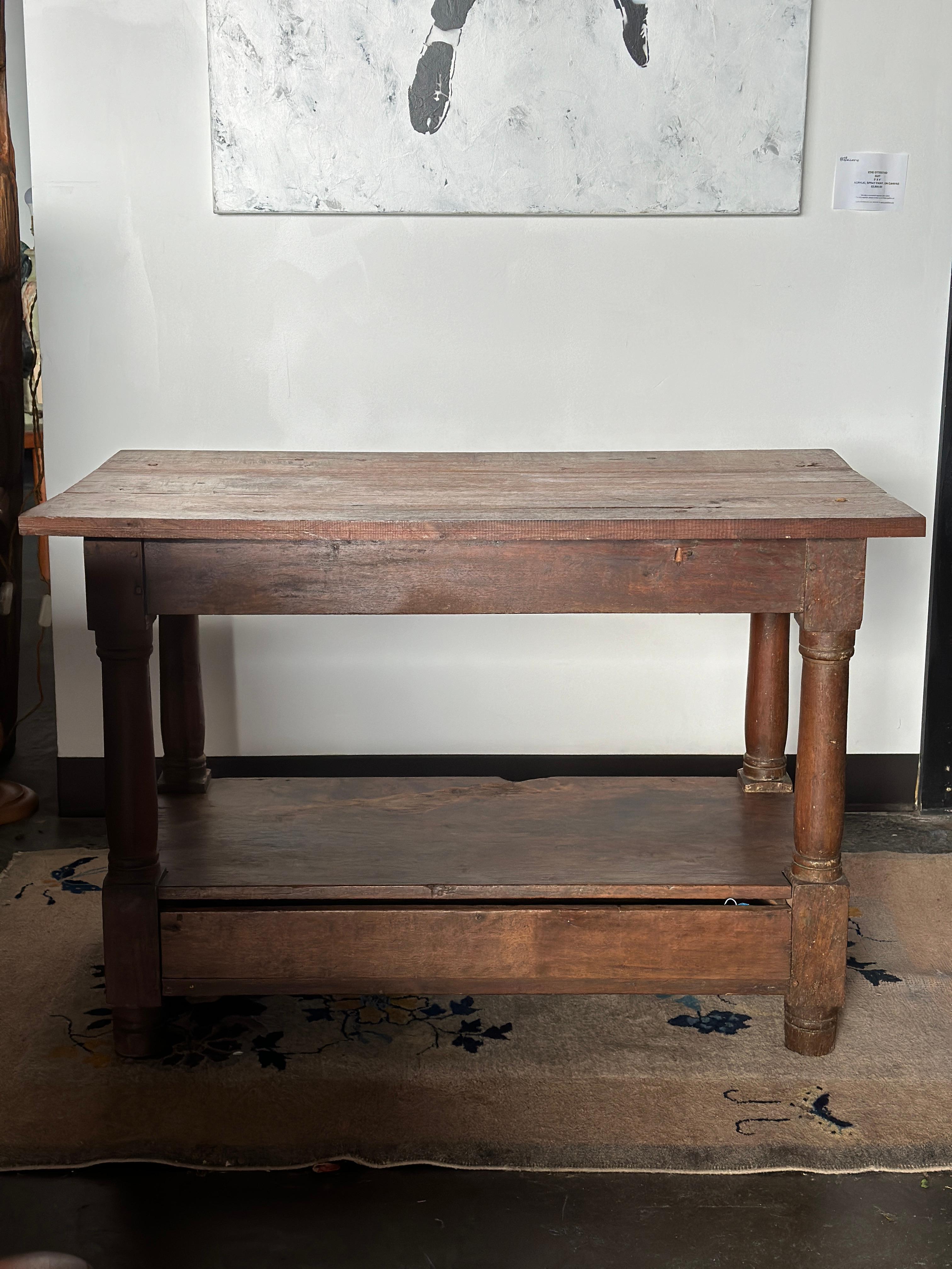 Wooden prep/center table with drawer. Perfectly paired with stools or situated with drinks, a floral arrangement, games, or books. A very sturdy old table that will live on for years to come. Age-consistent wear present with minor staining. Some