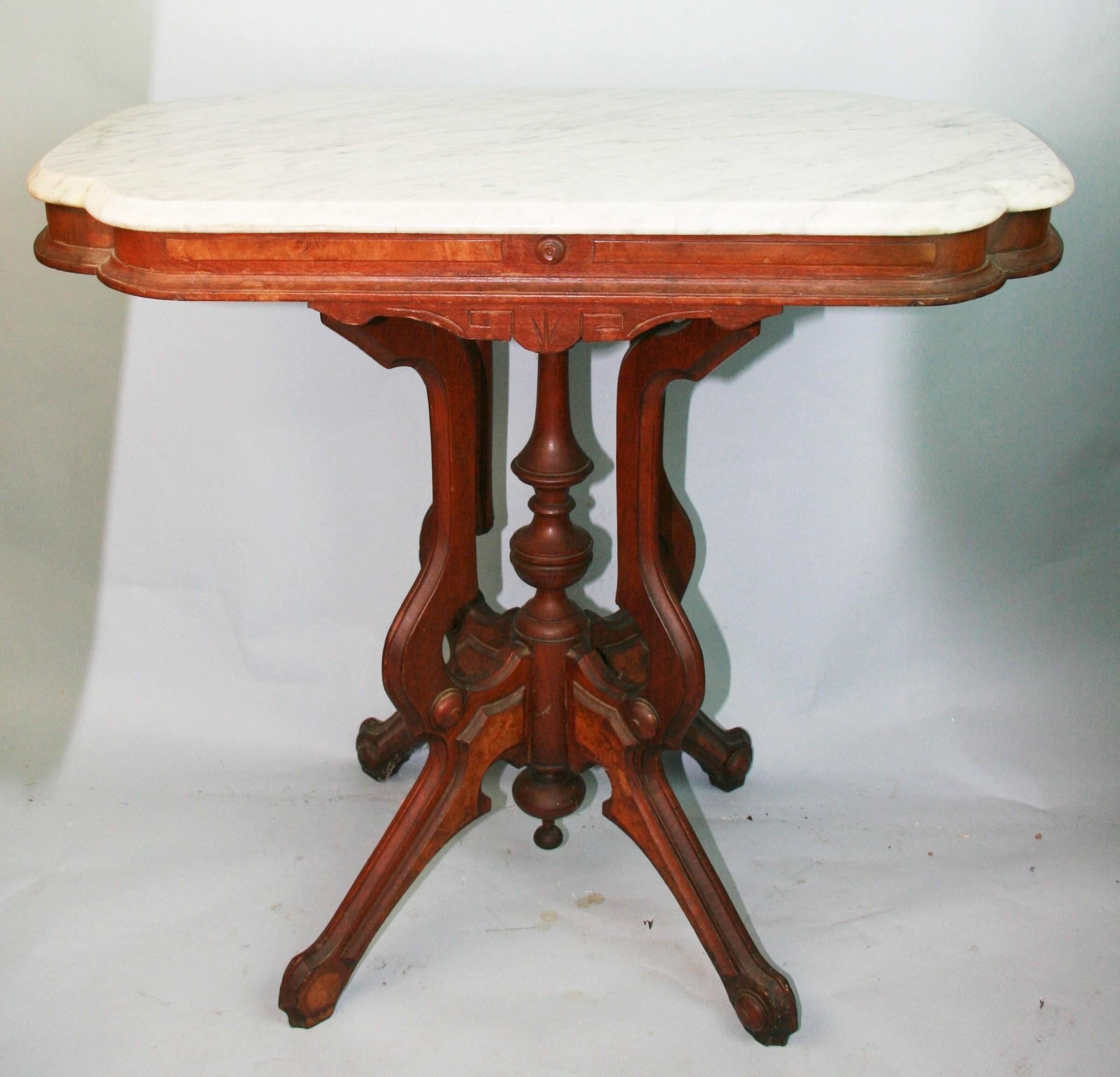 Antique Victorian Eastlake Walnut and Burl carved marble parlor side table
A grand rectangular marble top and turned center post surrounded by carved panels
Missing 2 carved medallions on foot
Circa 1890
