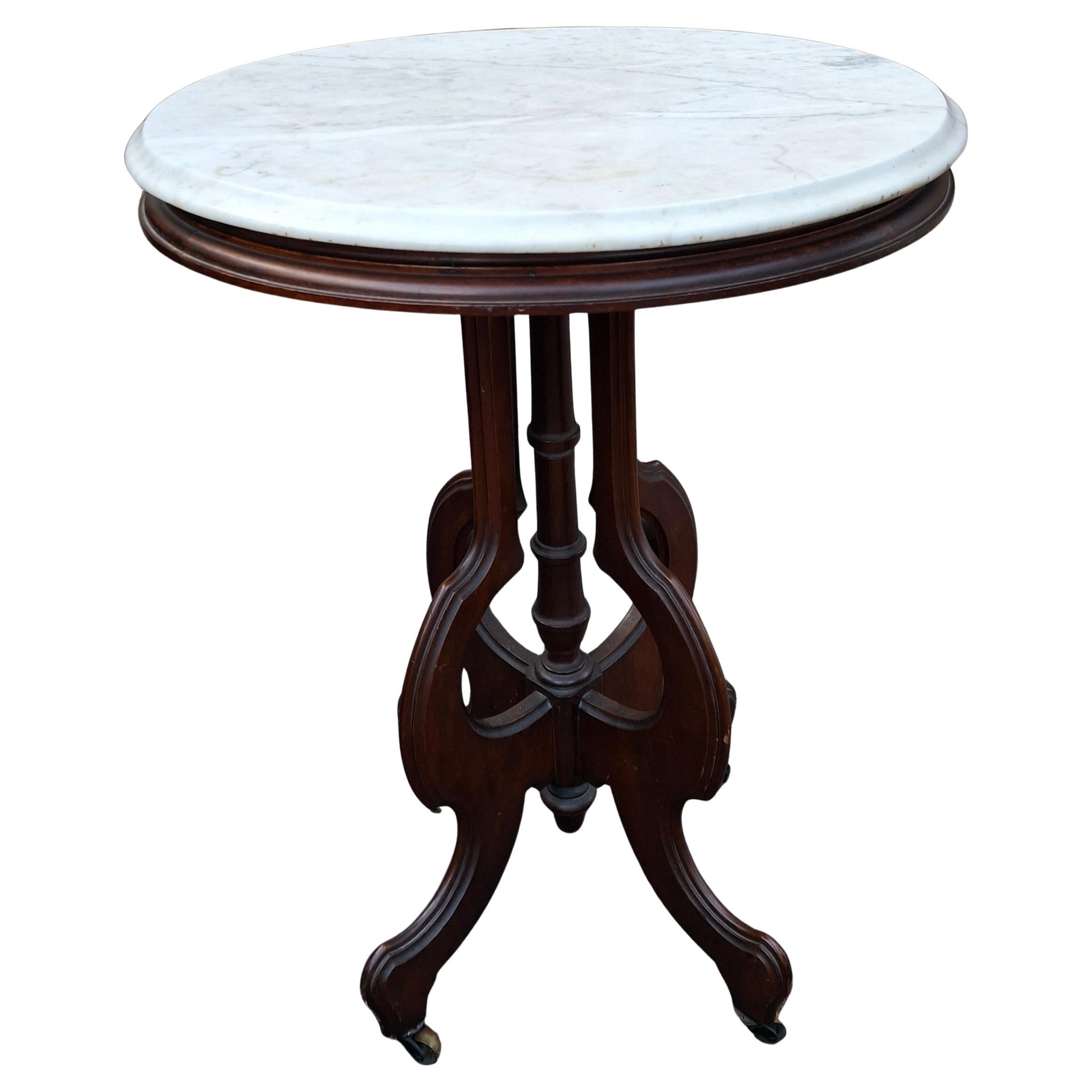 Late 19th Century Eastlake Style Walnut and Marble Tip Oval Rolling Side Table